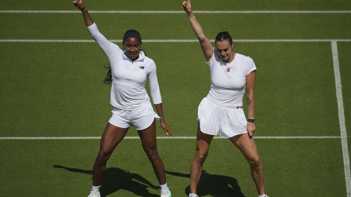 Aryna Sabalenka of Belarus, right, and Coco Gauff of United States dance during a practice session ahead of the Wimbledon Championships in London, Friday, June 27, 2025.