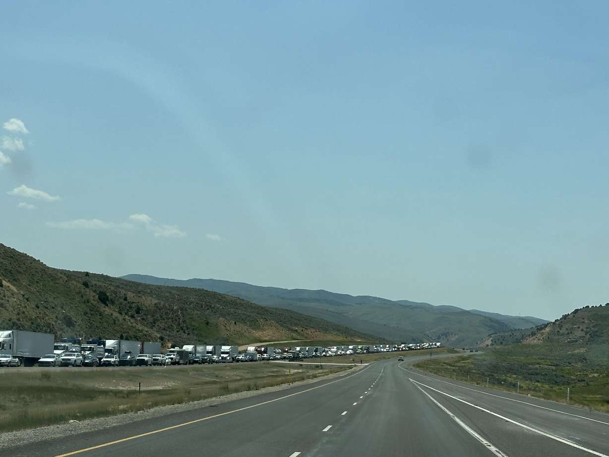 Two people were transported to the hospital and traffic was significantly backed up after a two-vehicle crash on I-80 near the Utah-Wyoming border Friday.
