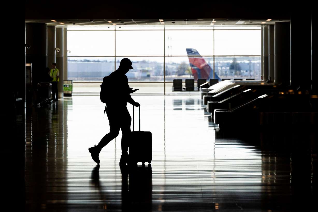 A passenger walks toward a security checkpoint at the Salt Lake City International Airport on March 23. Over 28.3 million travelers passed through the airport in 2024, the busiest year ever for the airport.