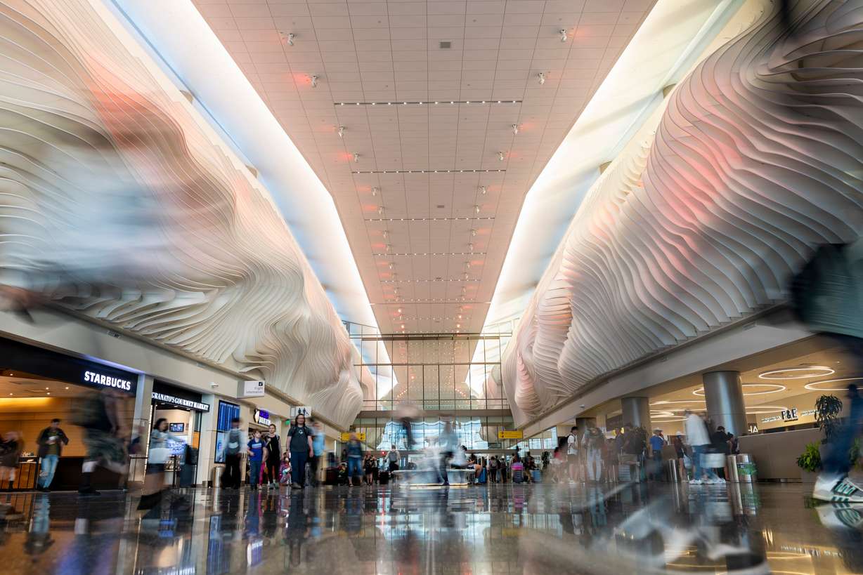 Passengers walk through the main entrance to the Salt Lake City International Airport on June 20, 2024. The airport said their goals are improve user experience and remain cost-effective for airlines.