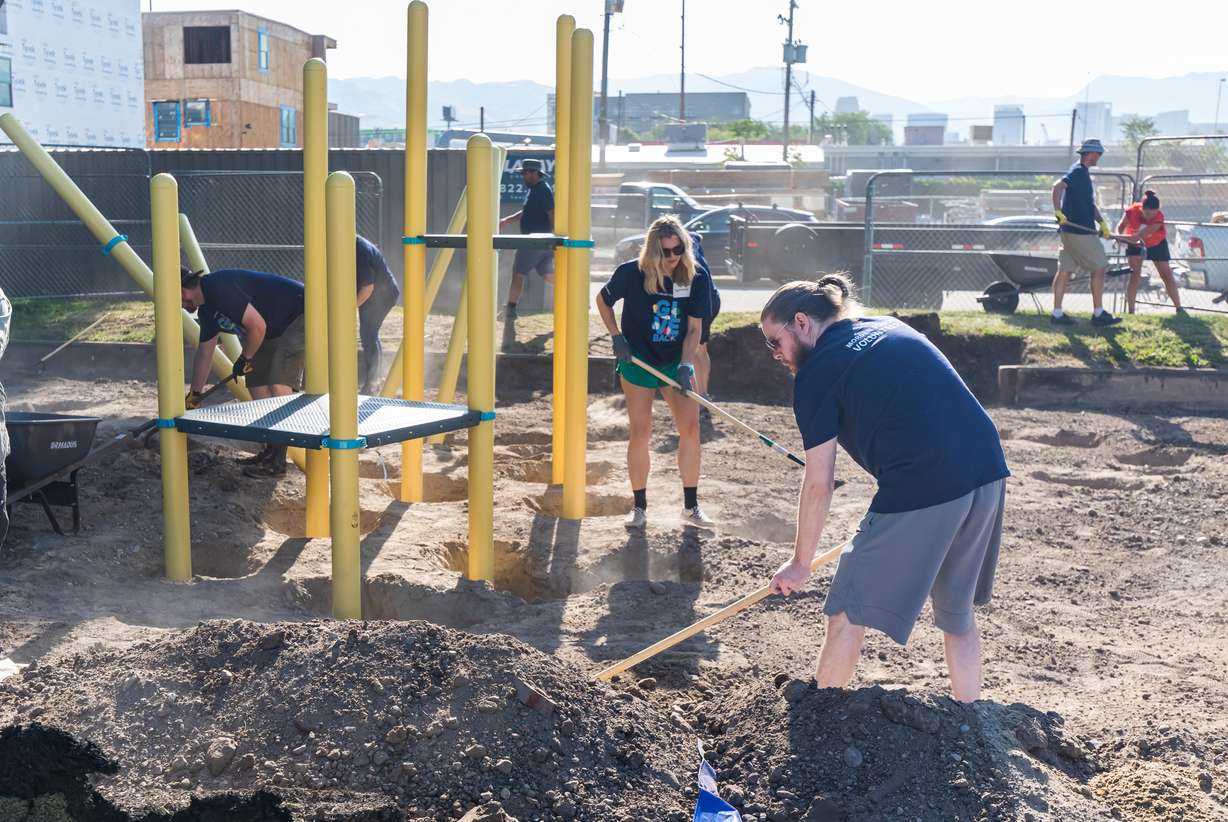Volunteers construct a new playground at Madsen Park in Salt Lake City on Friday. More park upgrades are planned for next year.