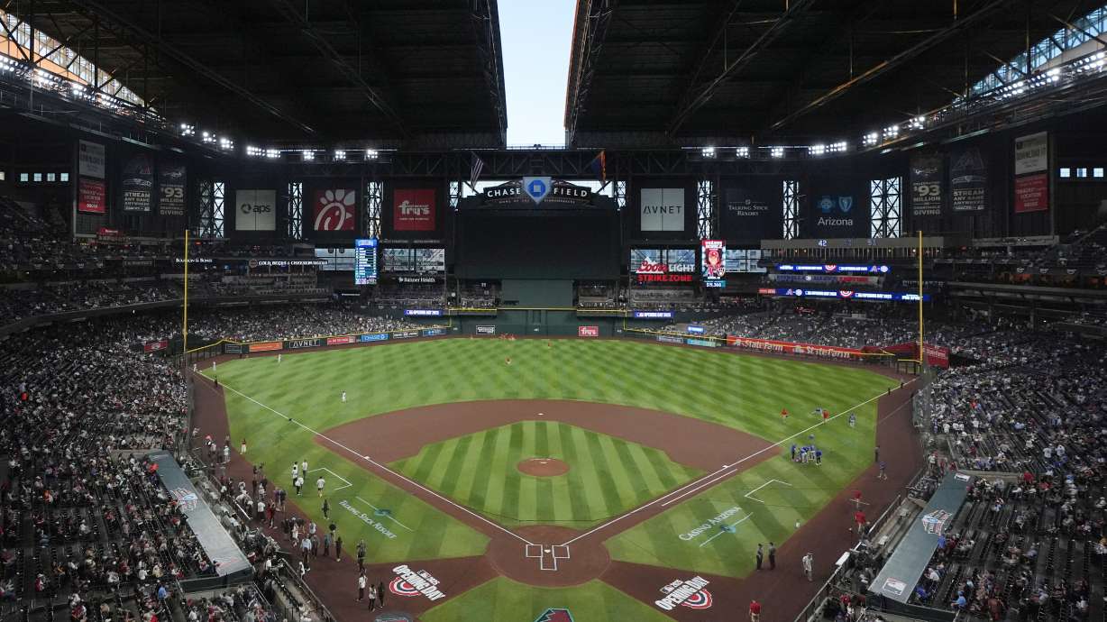 FILE - The roof to Chase Field begins to open prior to an opening-day baseball game between the Arizona Diamondbacks and the Chicago Cubs, March 27, 2025, in Phoenix.