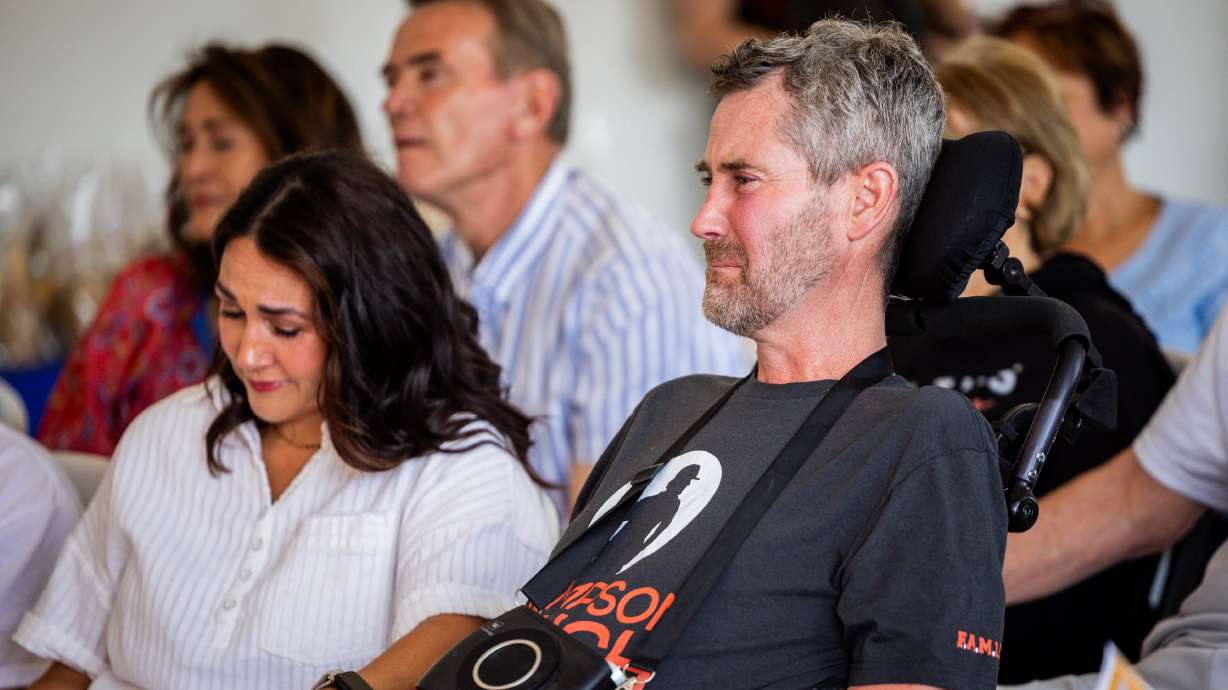 Erik Thompson and his wife, Skye, during a ceremony in South Weber Friday. The Have a Heart Home Foundation and Nilson Homes built a new house for the family after the former high school football coach was diagnosed with ALS.
