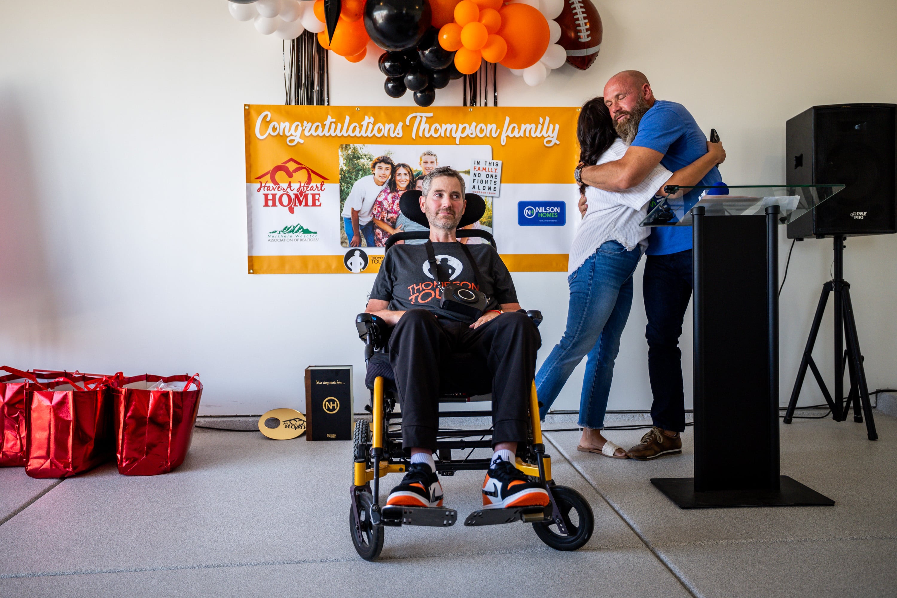 Nilson Homes owner and CEO Jed Nilson, right, hugs Skye Thompson after presenting a key to her and her husband Erik Thompson in South Weber on Friday. The Have a Heart Home Foundation and Nilson Homes built the house for the family after Erik Thompson was diagnosed with ALS.