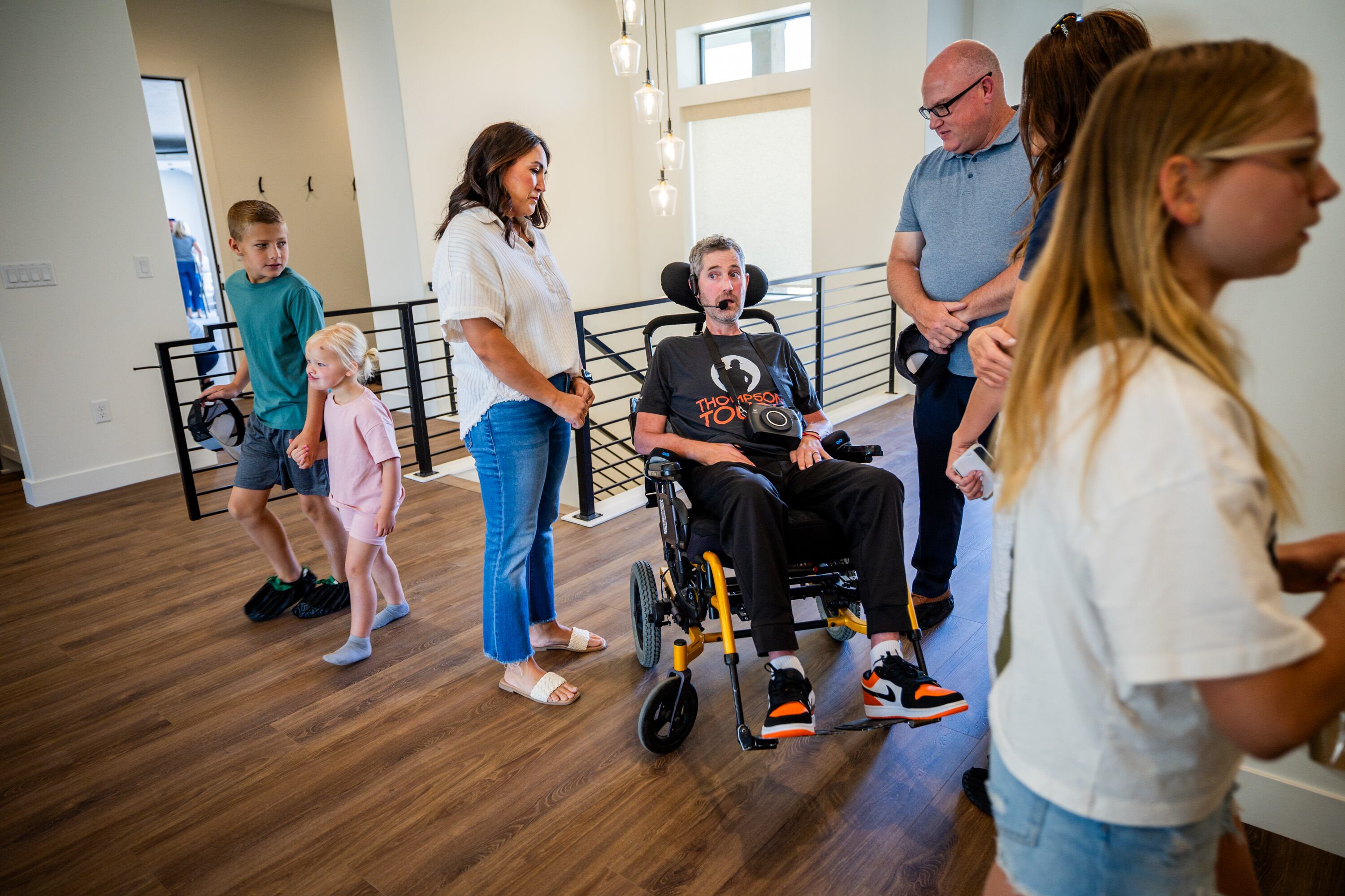 Brian Berrong speaks to Erik Thompson and his wife Skye after a ceremony to commemorate their new home in South Weber on Friday. Skye Thompson invited those who came to the ceremony to tour the family's new home.