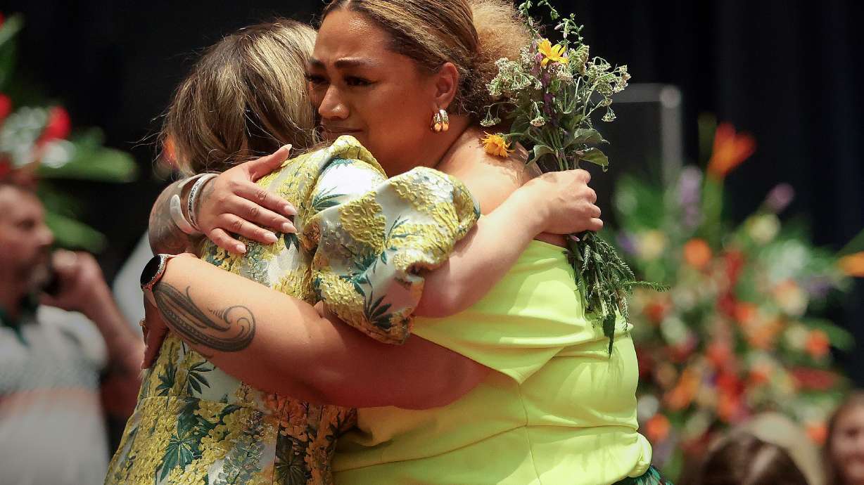 Laura Ah Loo, left, hugs Ashley Auva’a at a celebration of life for Laura’s husband, Afa Ah Loo, who was shot and killed as an innocent bystander during a No Kings protest, at the Salt Palace Convention Center in Salt Lake City on Friday.