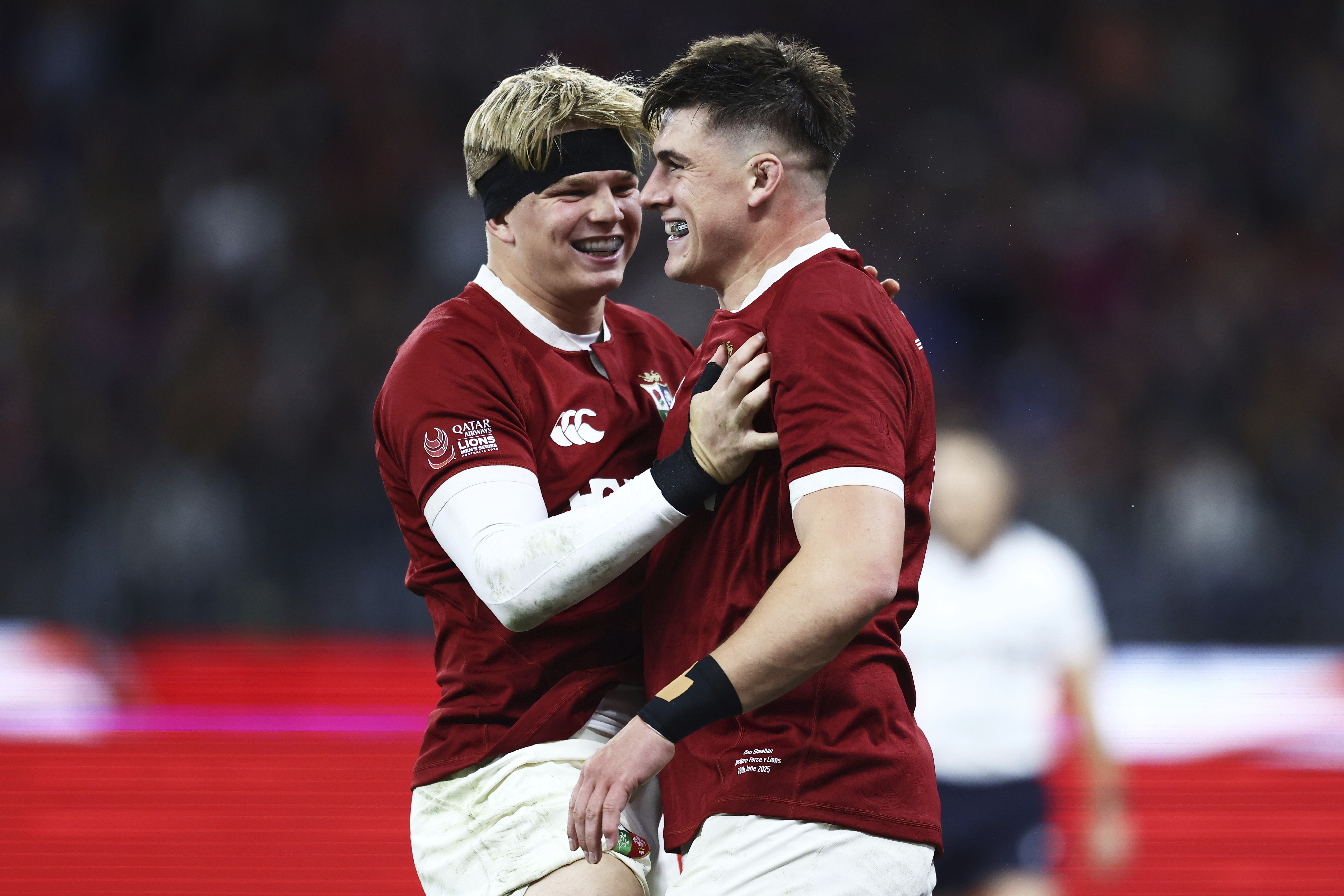 Dan Sheehan, right, of the British & Irish Lions is congratulated by teammate Henry Pollock after scoring his team's first try during their rugby match against the Western Force in Perth, Australia, Saturday, June 28, 2025. 