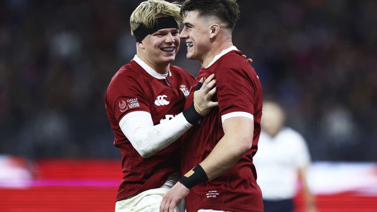 Dan Sheehan, right, of the British & Irish Lions is congratulated by teammate Henry Pollock after scoring his team's first try during their rugby match against the Western Force in Perth, Australia, Saturday, June 28, 2025.