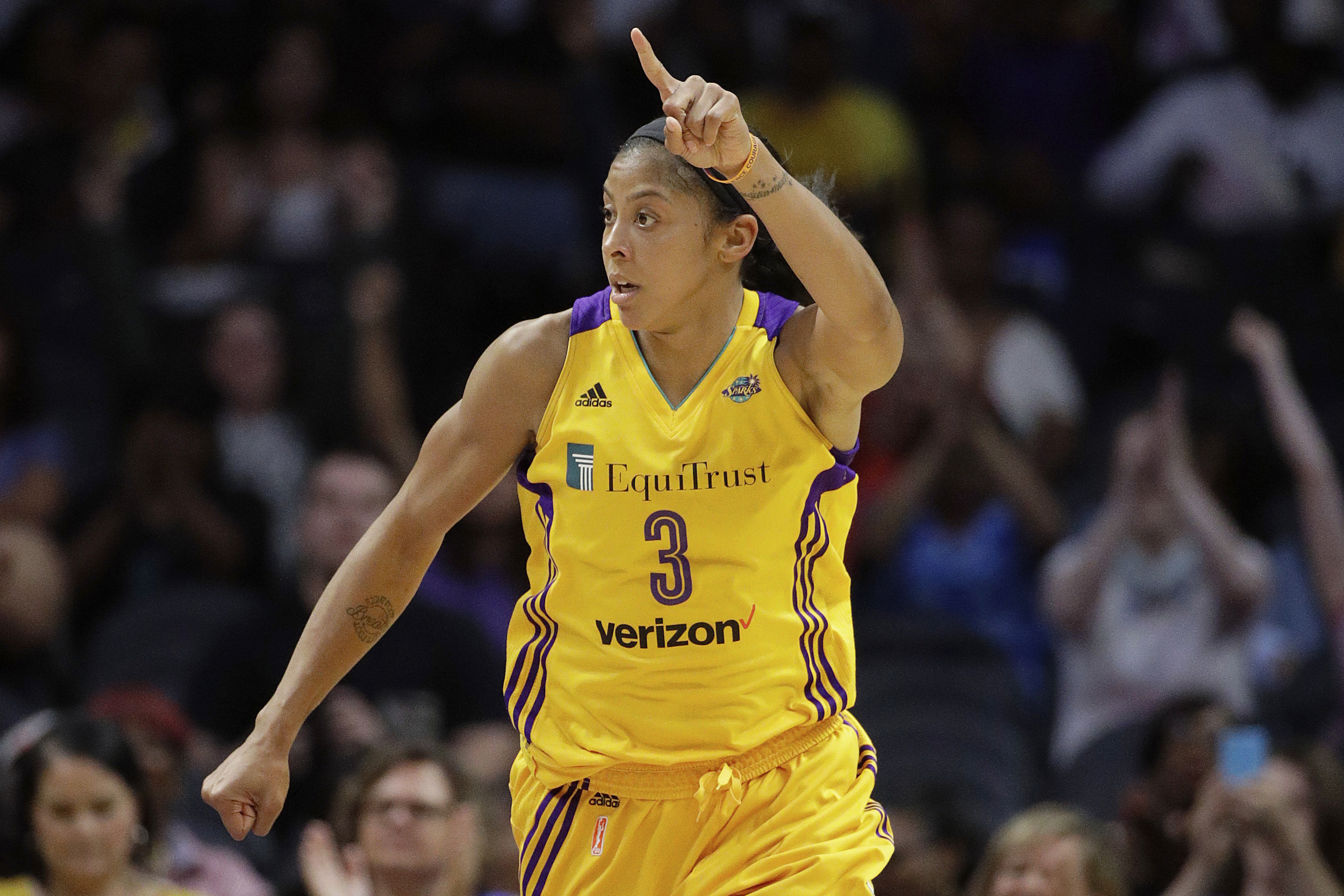 FILE - In this Aug. 4, 2017, file photo, Los Angeles Sparks' Candace Parker celebrates her basket against the New York Liberty during the second half of a WNBA basketball game in Los Angeles.