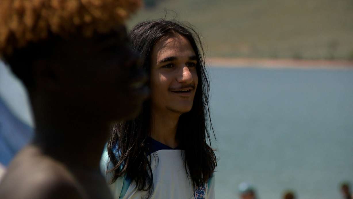 Anas Mohammed kicks around a soccer ball with some friends at East Canyon Reservoir Friday.