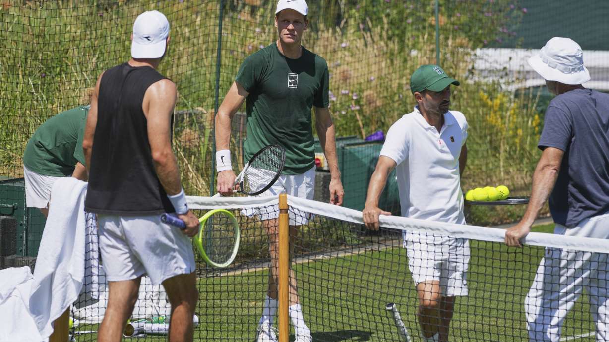 Jannik Sinner of Italy, center, attends a practice session ahead of the Wimbledon Championships in London, Friday, June 27, 2025.