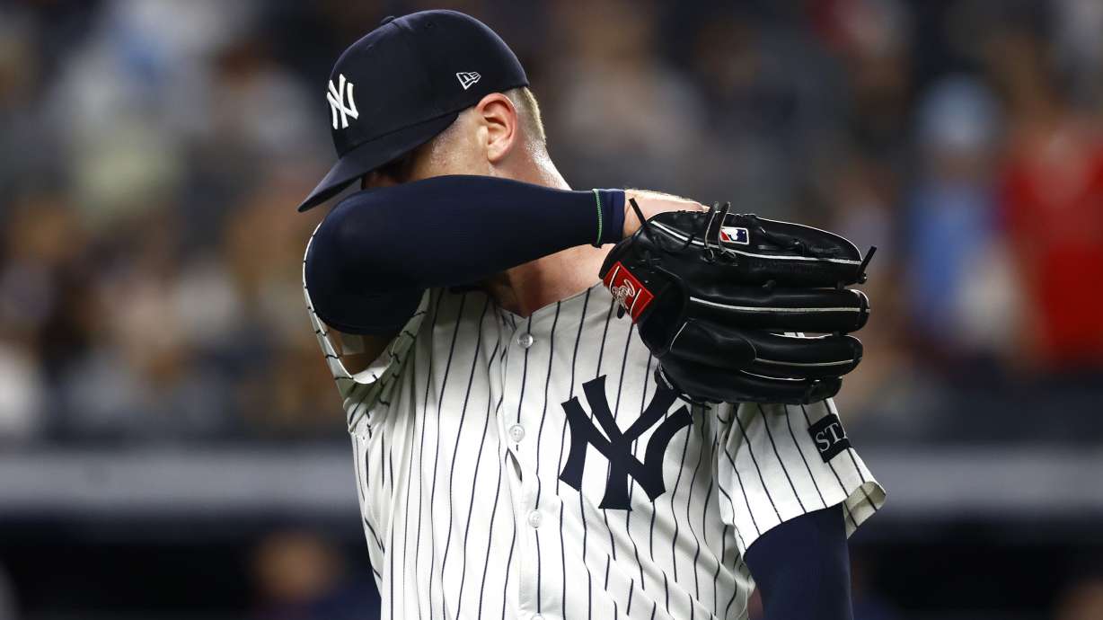 New York Yankees pitcher Ian Hamilton reacts on his way to the dugout during the ninth inning of a baseball game against the Boston Red Sox, Saturday, June 7, 2025, in New York.