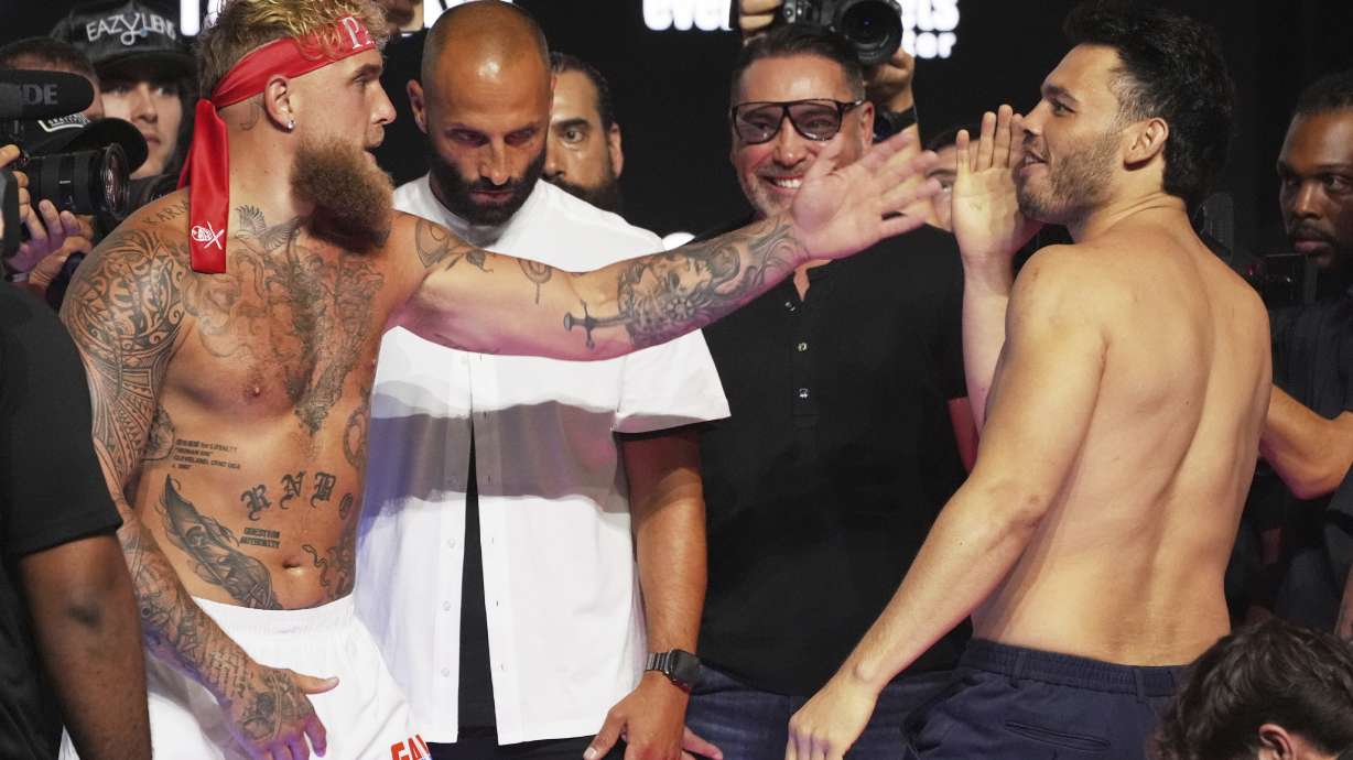 Jake Paul, left, and Julio Cesar Chavez Jr., right, taunt each other following a weigh-in ahead of their cruiserweight boxing match, Friday, June 27, 2025, in Anaheim, Calif.