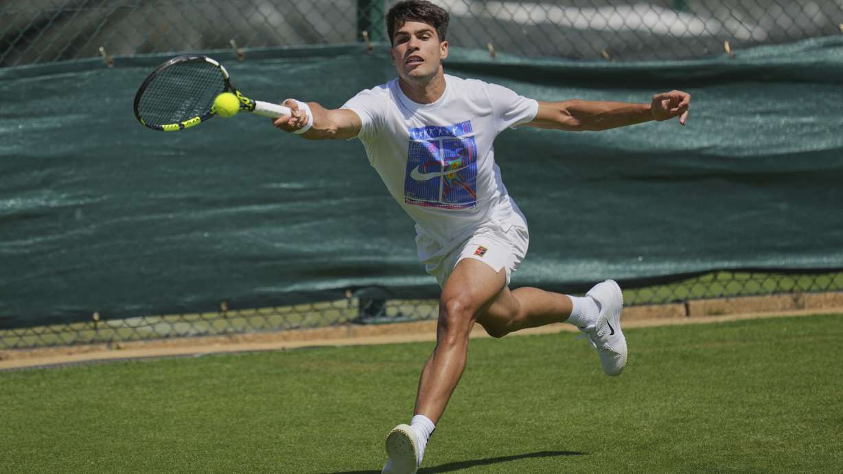 Carlos Alcaraz of Spain plays a return during a practice session ahead of the Wimbledon Championships in London, Friday, June 27, 2025.