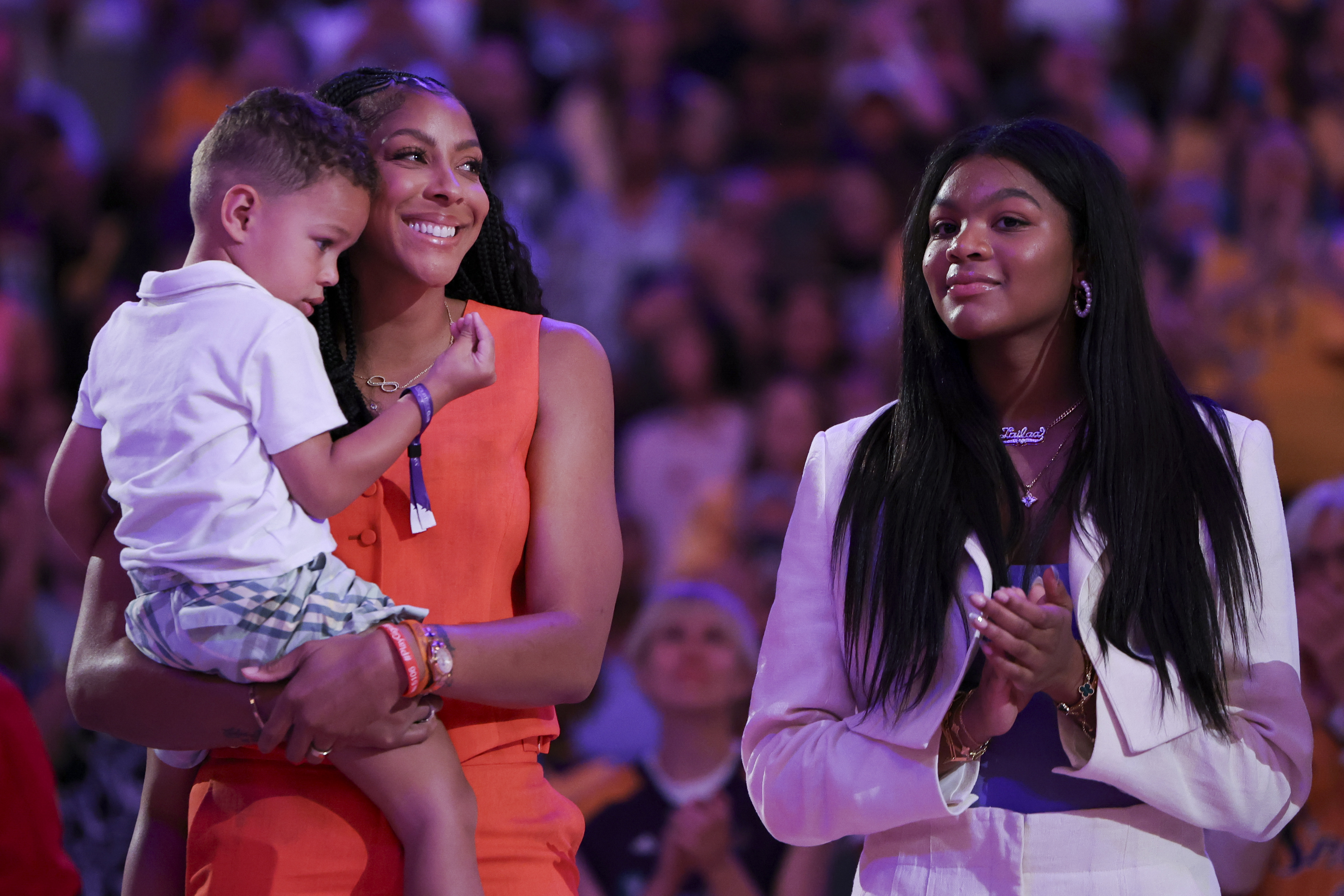 Former Los Angeles Sparks player Candace Parker, second from left, reacts with her family during her jersey retirement ceremony during a WNBA basketball game between the Sparks and the Chicago Sky, Sunday, June 29, 2025, in Los Angeles. 