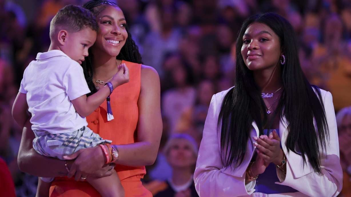 Former Los Angeles Sparks player Candace Parker, second from left, reacts with her family during her jersey retirement ceremony during a WNBA basketball game between the Sparks and the Chicago Sky, Sunday, June 29, 2025, in Los Angeles.