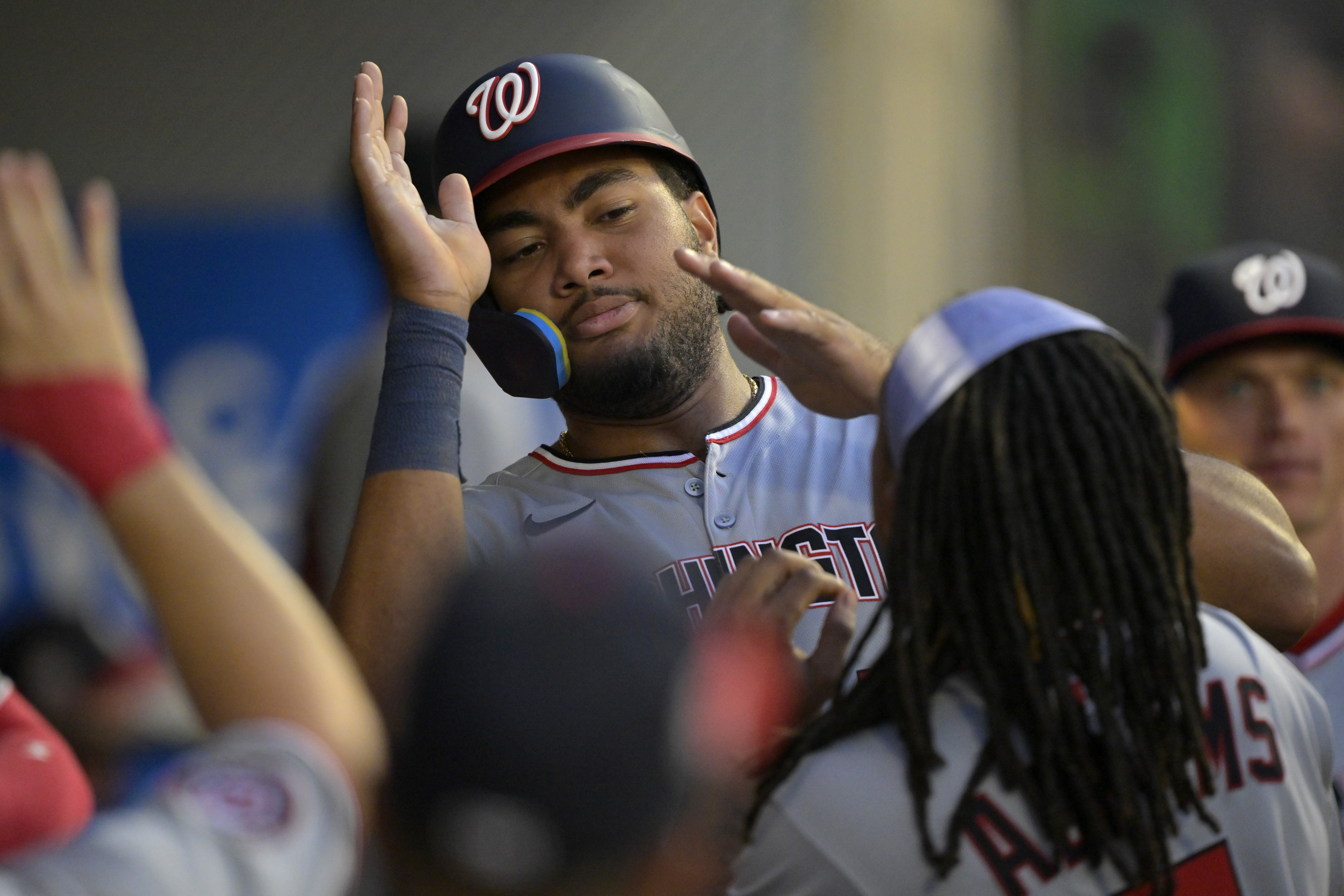 Washington Nationals' James Wood is greeted in the dugout after scoring on a double by Nathaniel Lowe during the fifth inning of a baseball game against the Los Angeles Angels, Friday, June 27, 2025, in Anaheim, Calif.