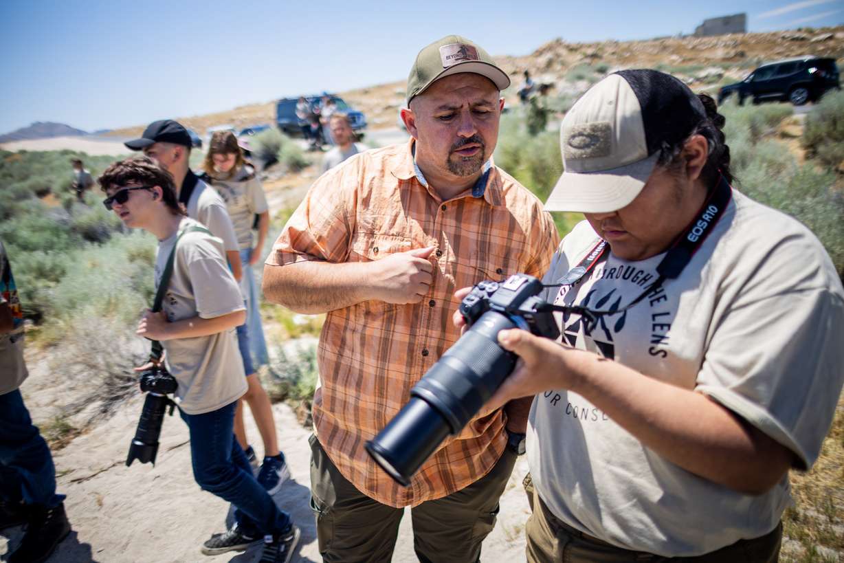 Mentor Jason Loftus, center, assists Kiarrah White, 14, take photos during “Lessons Through the Lens: Kids for Conservation,” a Utah Wildlife Federation summer photography camp over four Saturdays for youth ages 12–18 at Antelope Island State Park in Syracuse on Saturday.