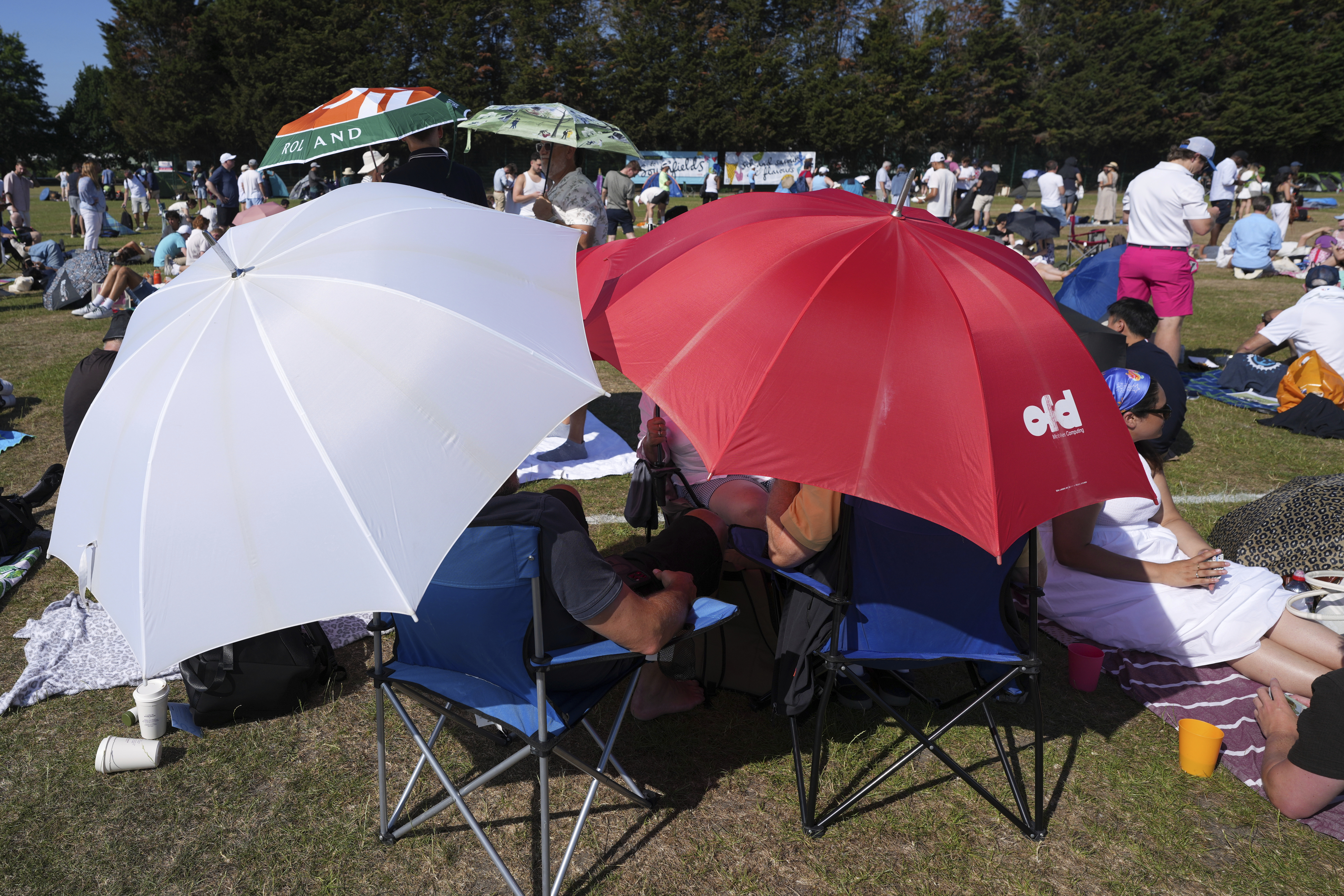 People queue at the entrance on the first day of the Wimbledon Tennis Championships in London, Monday, June 30, 2025. 