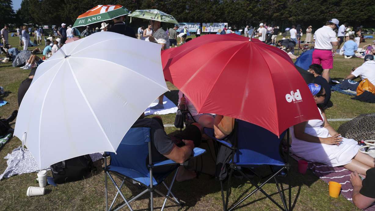 People queue at the entrance on the first day of the Wimbledon Tennis Championships in London, Monday, June 30, 2025.