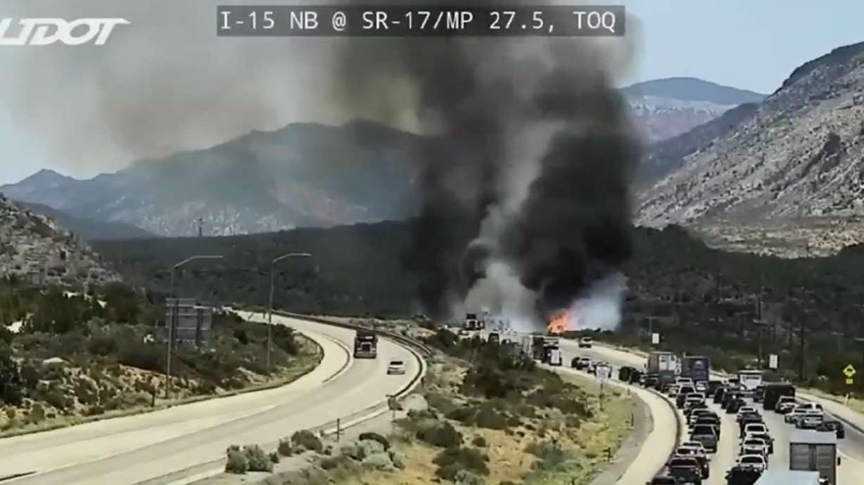 A brush fire sends smoke billowing into the sky along I-15 near Toquerville, Sunday.