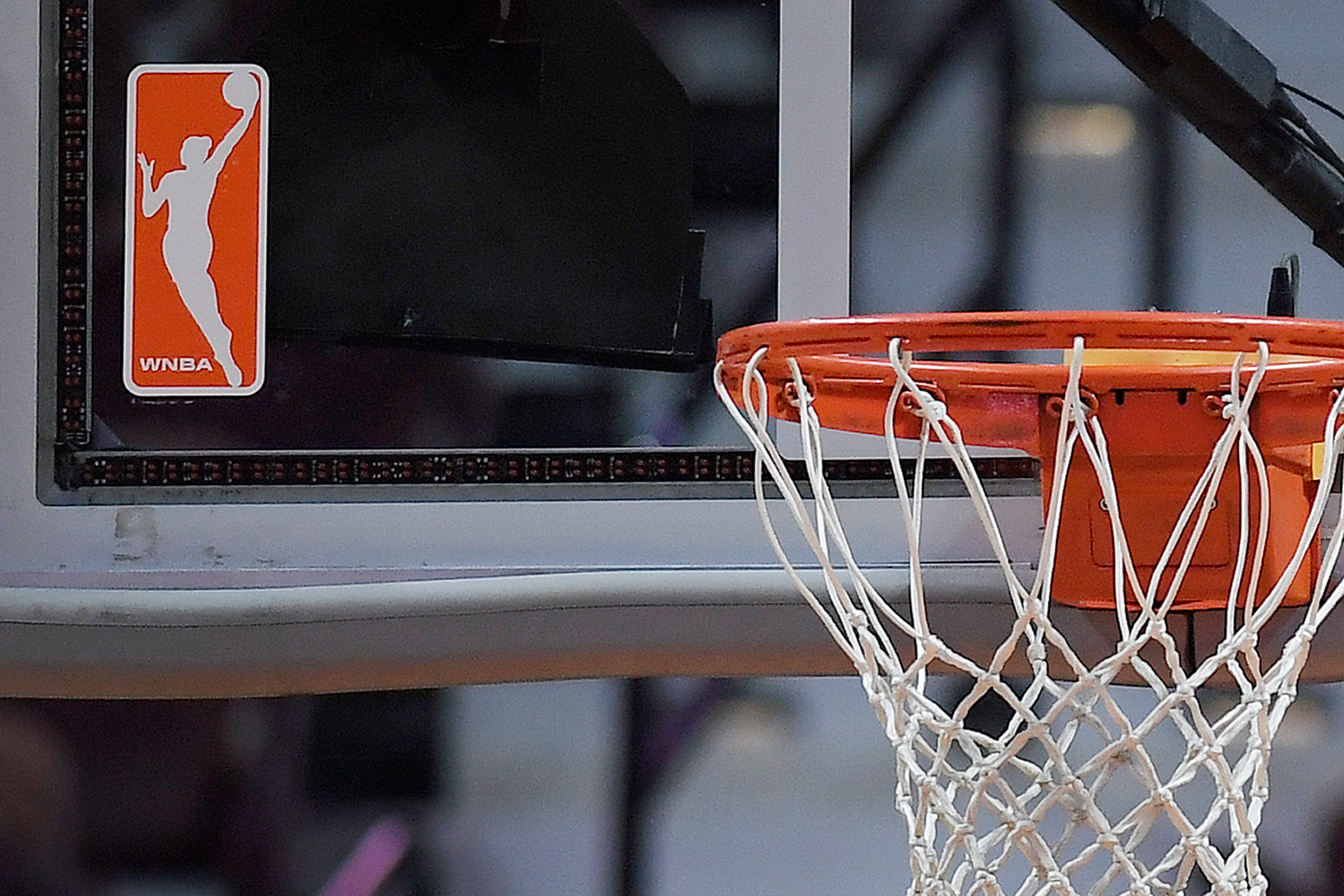 FILE - The WNBA logo is seen near a hoop before an WNBA basketball game at Mohegan Sun Arena, Tuesday, May 14, 2019, in Uncasville, Conn. 