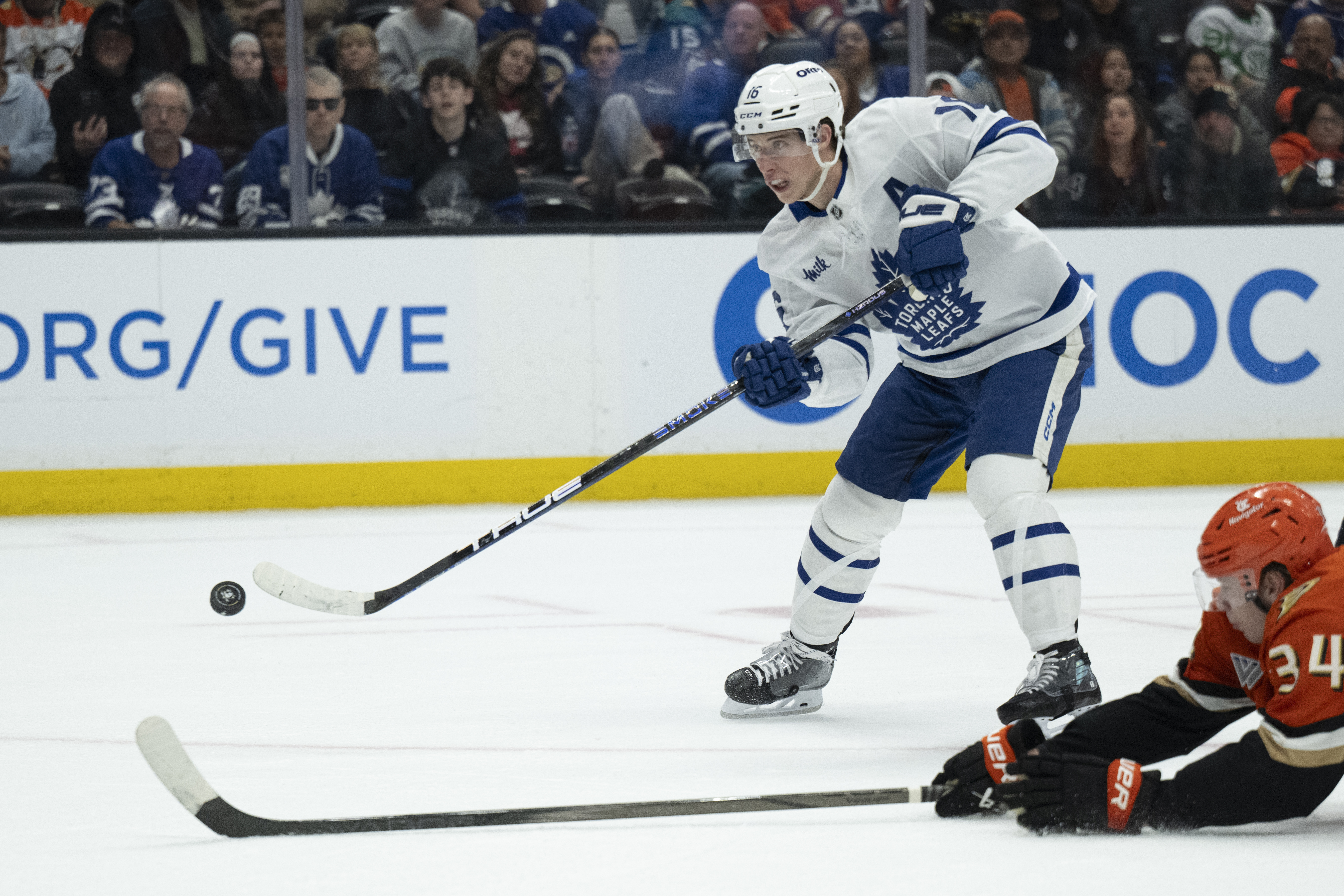 FILE - Toronto Maple Leafs right wing Mitch Marner (16) shoots past Anaheim Ducks defenseman Pavel Mintyukov (34) during the second period of an NHL hockey game, March 30, 2025, in Anaheim, Calif.