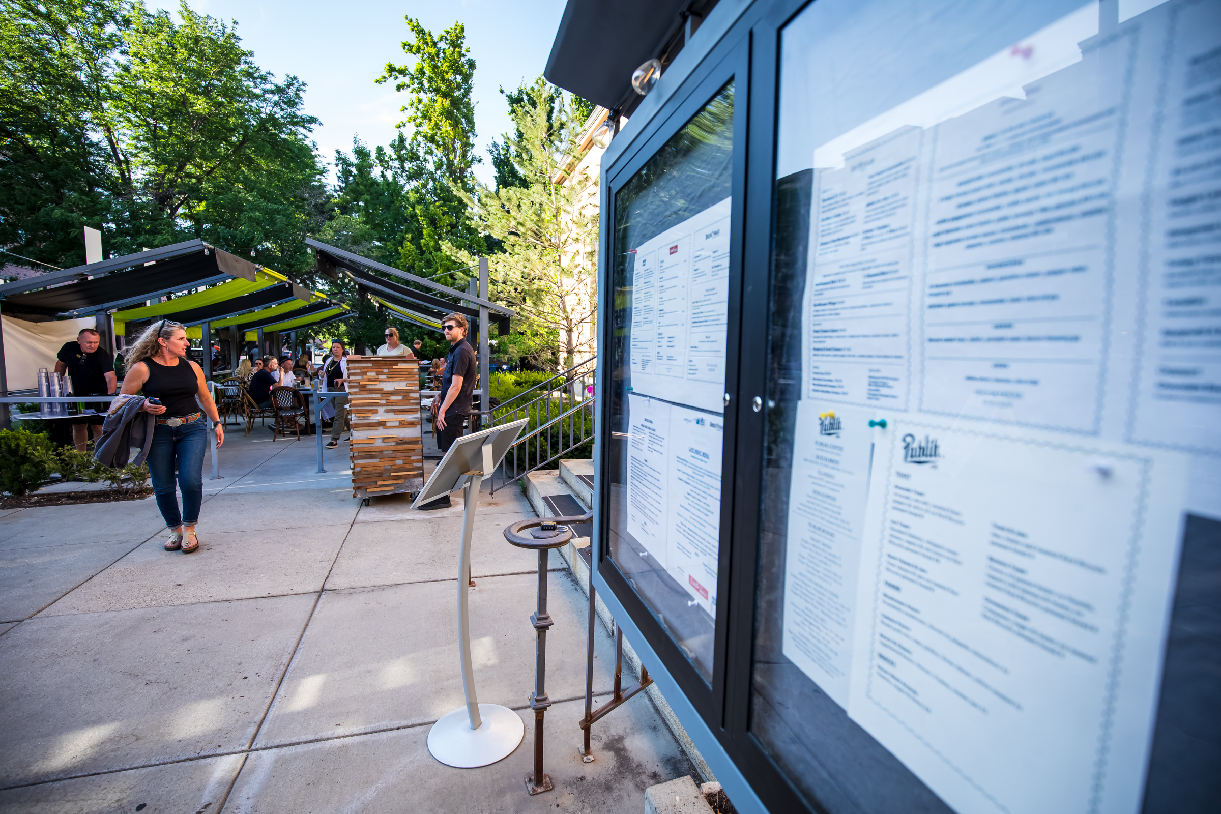 People sit by the outside patio in front of Sugar House Station in Salt Lake City on Wednesday. The business has had a strong start since opening along Highland Drive this year, after construction ended on the road.