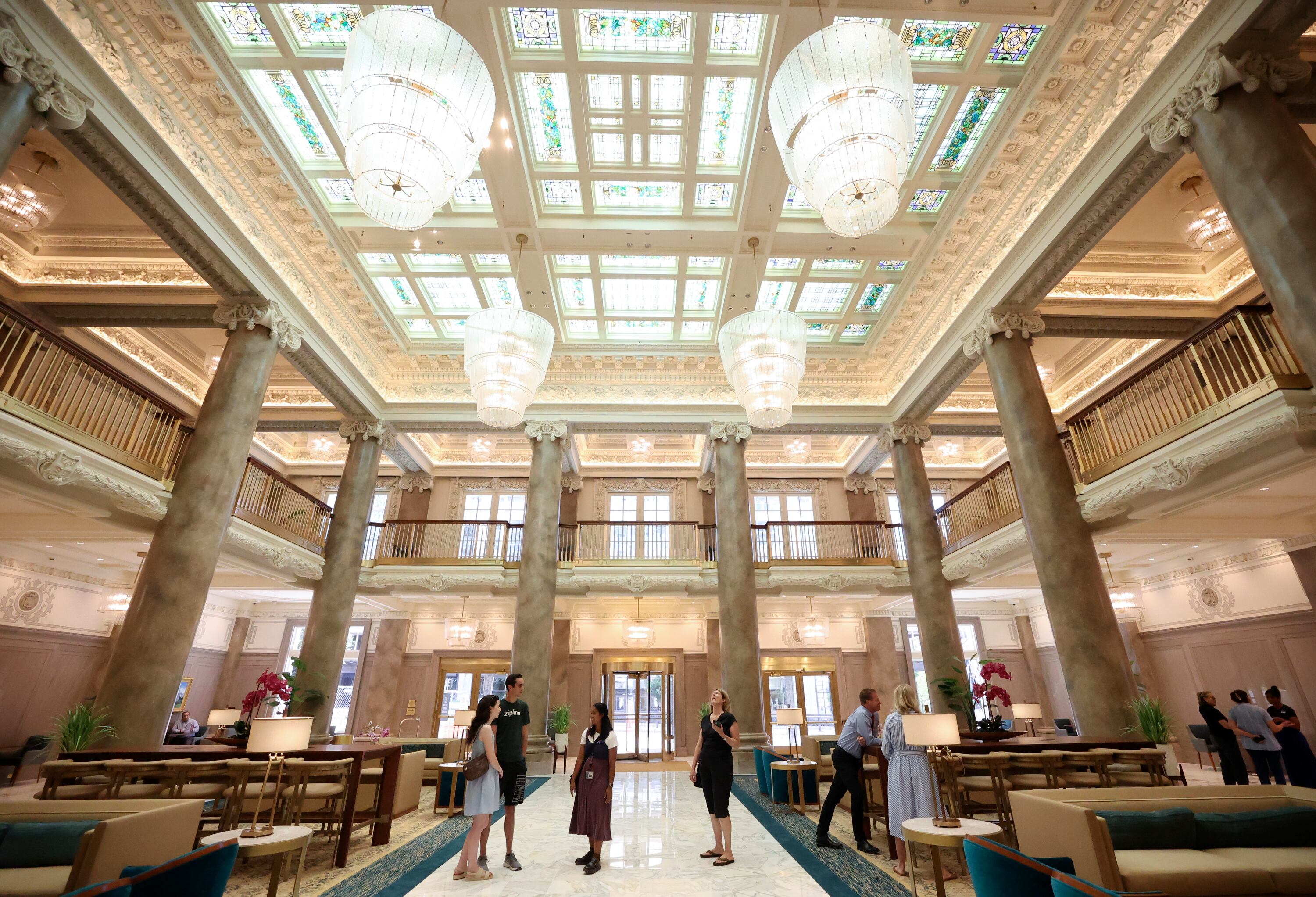 People look around the lobby of the Joseph Smith Memorial Building on the first day it is reopened after a two-and-a-half-year renovation in Salt Lake City on Monday. Some parts of the building are still under construction.