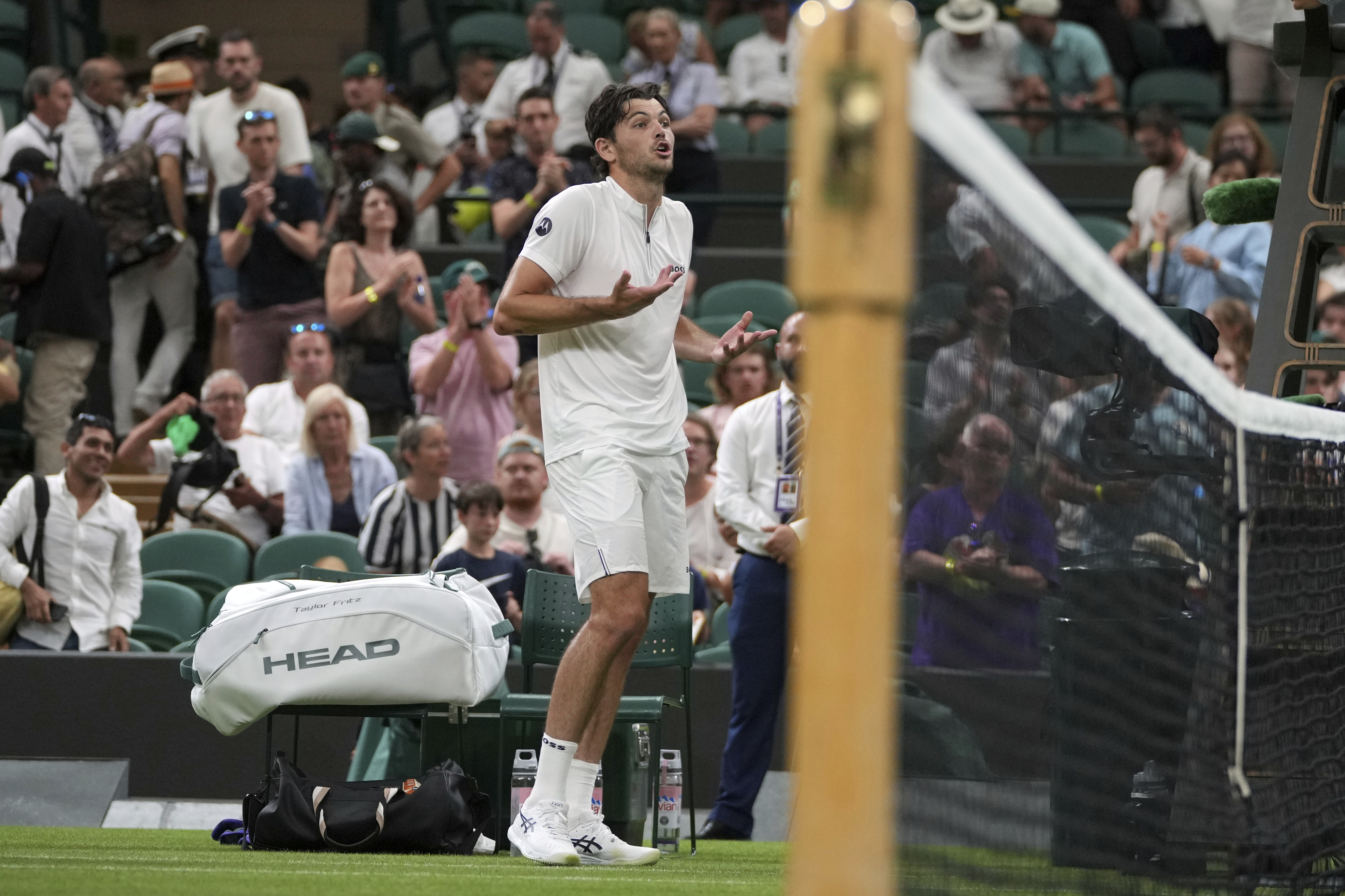 Taylor Fritz of the U.S. reacts after the first round men's single match against Giovanni Mpetshi Perricard of France was suspended at the Wimbledon Tennis Championships in London, Monday, June 30, 2025. 