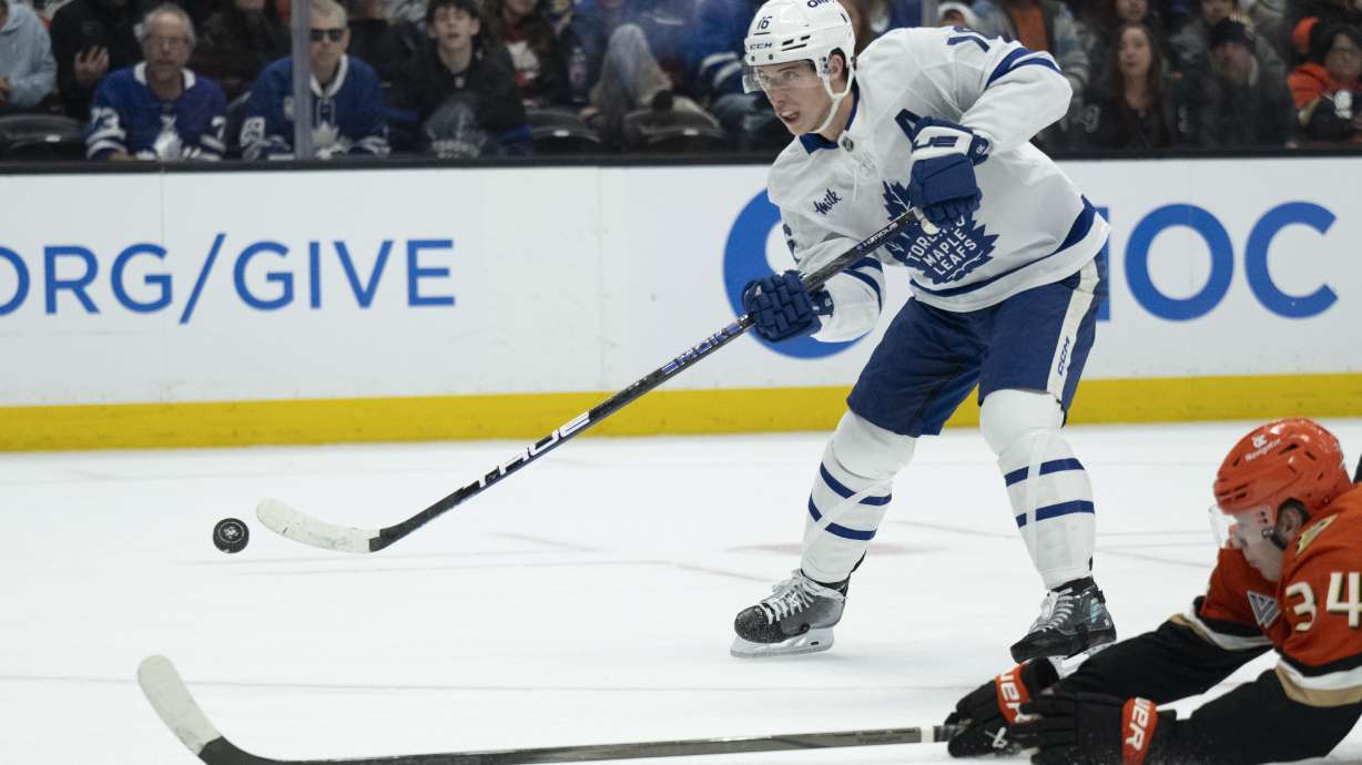 FILE - Toronto Maple Leafs right wing Mitch Marner (16) shoots past Anaheim Ducks defenseman Pavel Mintyukov (34) during the second period of an NHL hockey game, March 30, 2025, in Anaheim, Calif.
