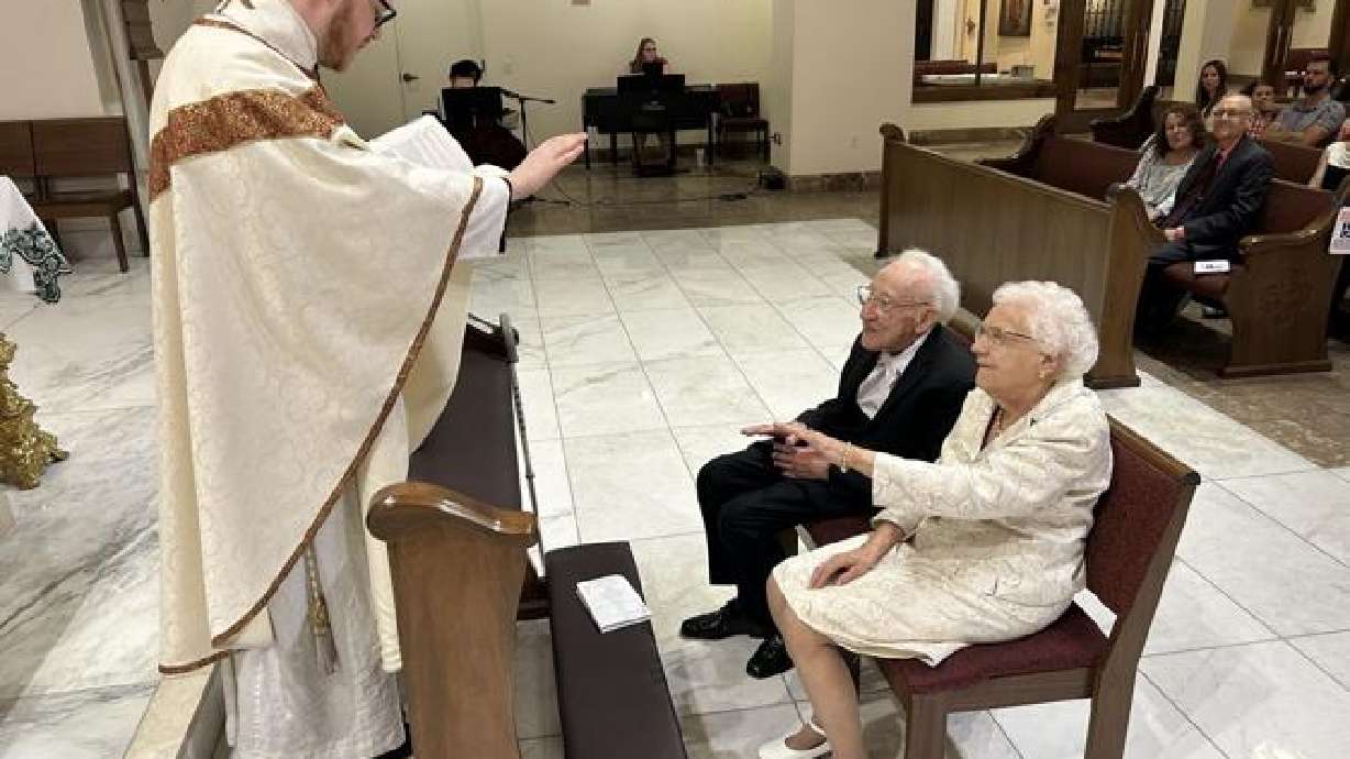 Father Tristan Dillon of St. George Catholic Church officiates the wedding vow renewal of Raymond and Margaret Ehrig, St. George, Saturday.