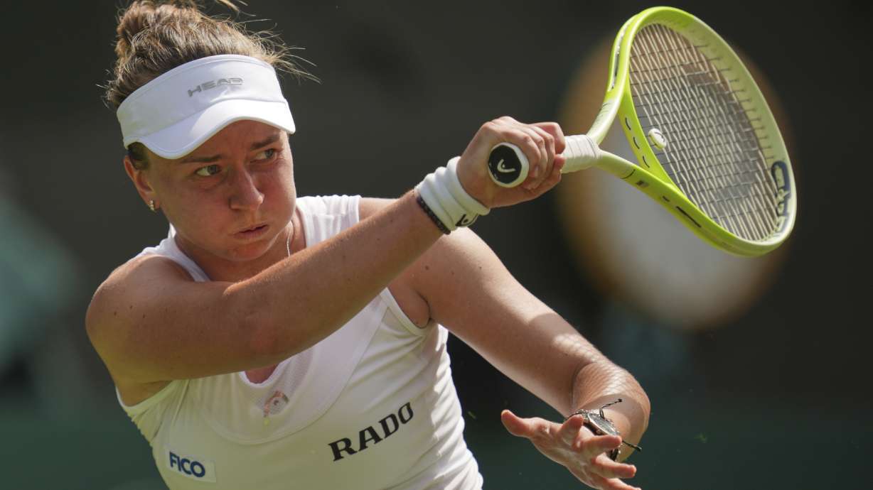 Barbora Krejcikova of Czech Republic returns to Alexandra Eala of the Philippines during their first round women's singles match at the Wimbledon Tennis Championships in London, Tuesday, July 1, 2025.