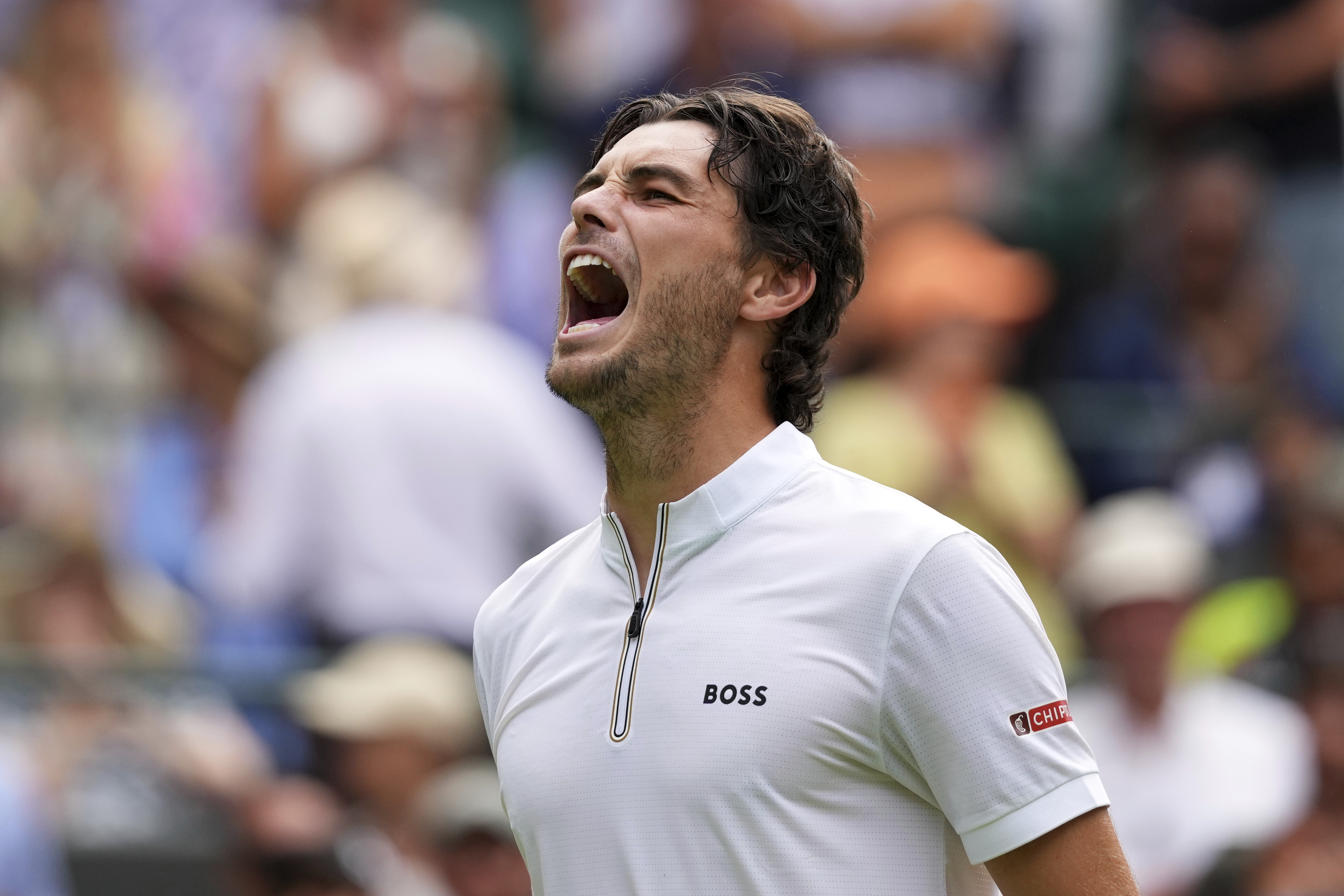 Taylor Fritz of the U.S. celebrates winning the first round men's singles match against Giovanni Mpetshi Perricard of France at the Wimbledon Tennis Championships in London, Tuesday, July 1, 2025.