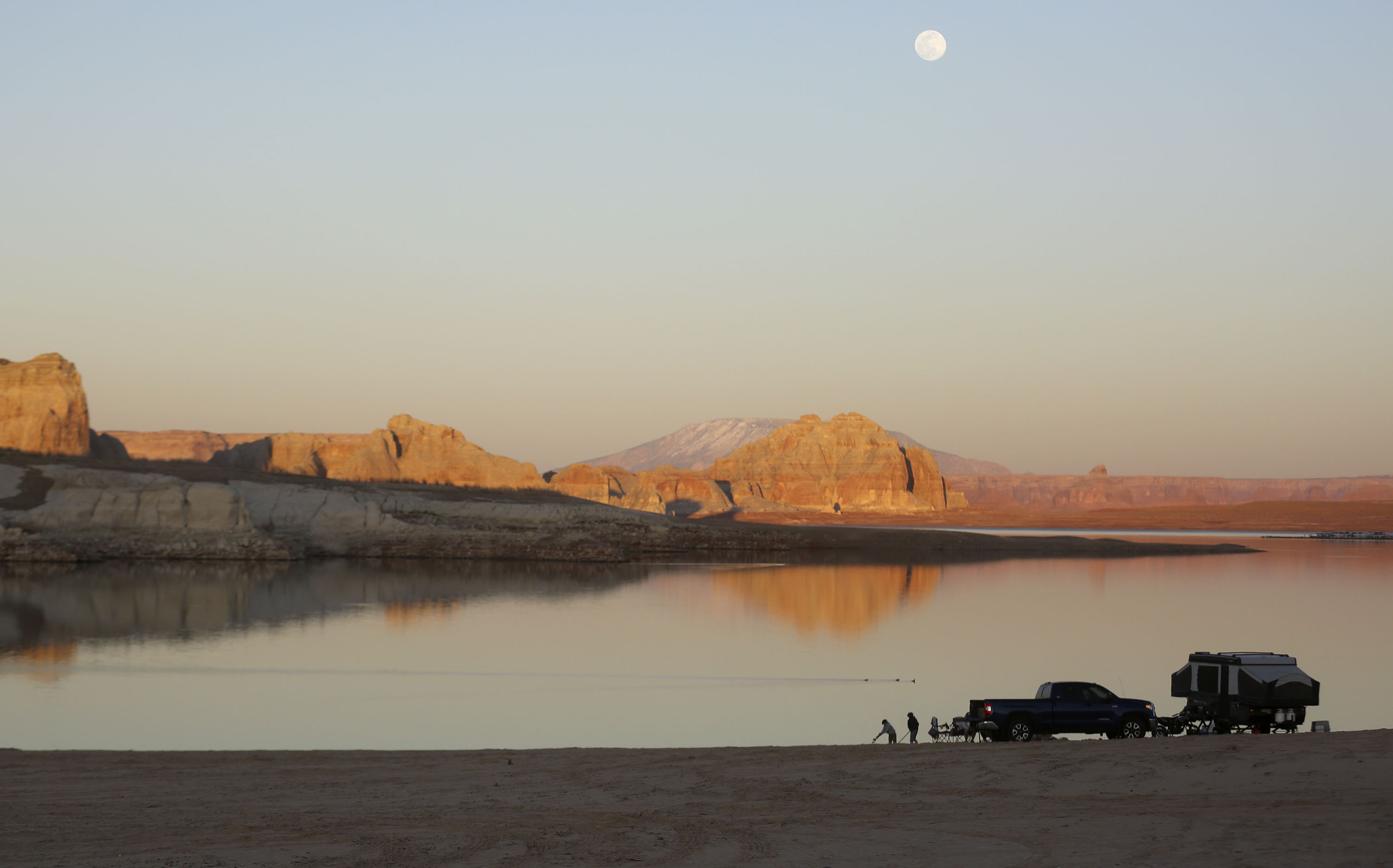 People camp on Lone Rock Beach in the Glen Canyon National Recreation Area at Lake Powell in Utah on March 27, 2021. A new survey showed Utahns broadly support environmental protections.
