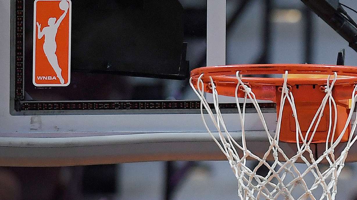 FILE - The WNBA logo is seen near a hoop before an WNBA basketball game at Mohegan Sun Arena, Tuesday, May 14, 2019, in Uncasville, Conn.