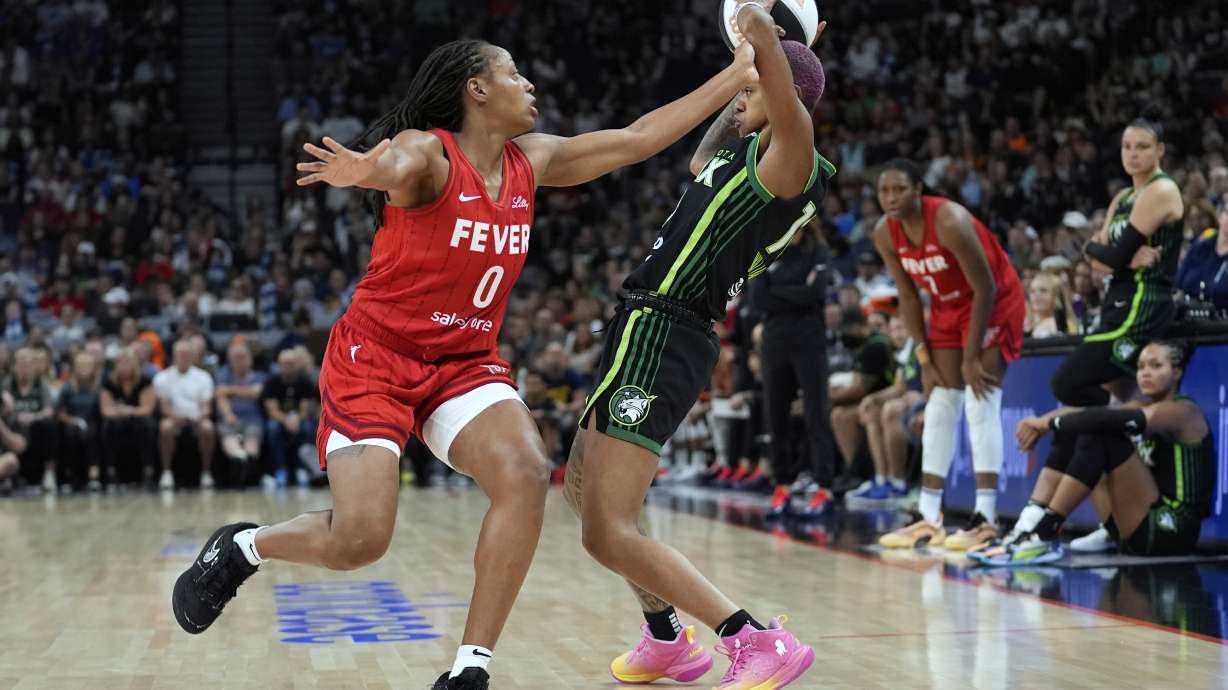 Minnesota Lynx guard Courtney Williams (10), right, handles the ball as Indiana Fever guard Kelsey Mitchell (0) defends during the first half of the WNBA Commissioner's Cup championship basketball game Tuesday, July 1, 2025, in Minneapolis.