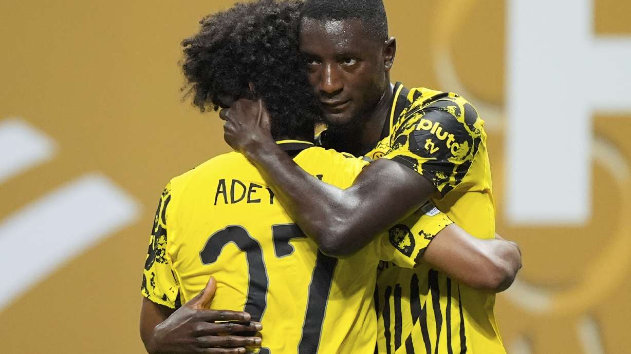 Borussia Dortmund's Serhou Guirassy, right, celebrates with teammate Karim Adeyemi after scoring his team's second goal during the Club World Cup round of 16 soccer match between Borussia Dortmund and CF Monterrey in Atlanta, Tuesday, July 1, 2025.