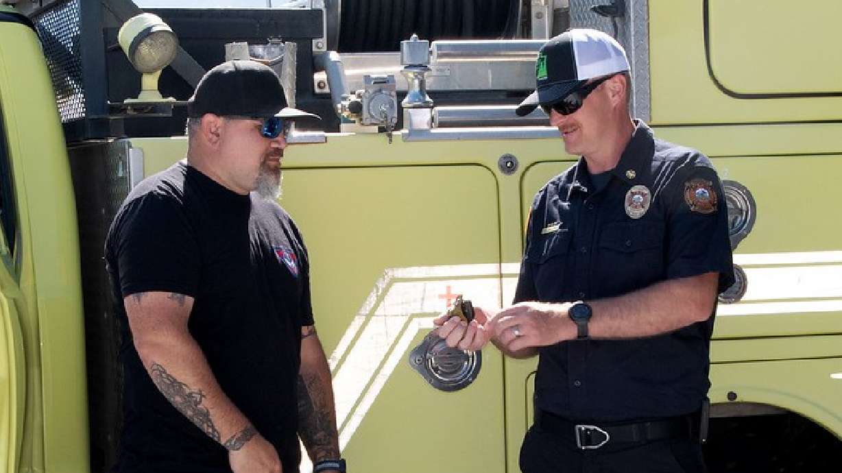 Dan Walton accepts the keys for the Type 6 fire truck from West Desert District Assistant Fire Management Office's Pila Malolo.