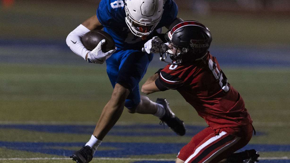 Fremont’s Salesi Moa (8) drives through a tackle by Weber’s Brock Dean (8) at Fremont High School in Plain City on Thursday, Oct. 10, 2024.
