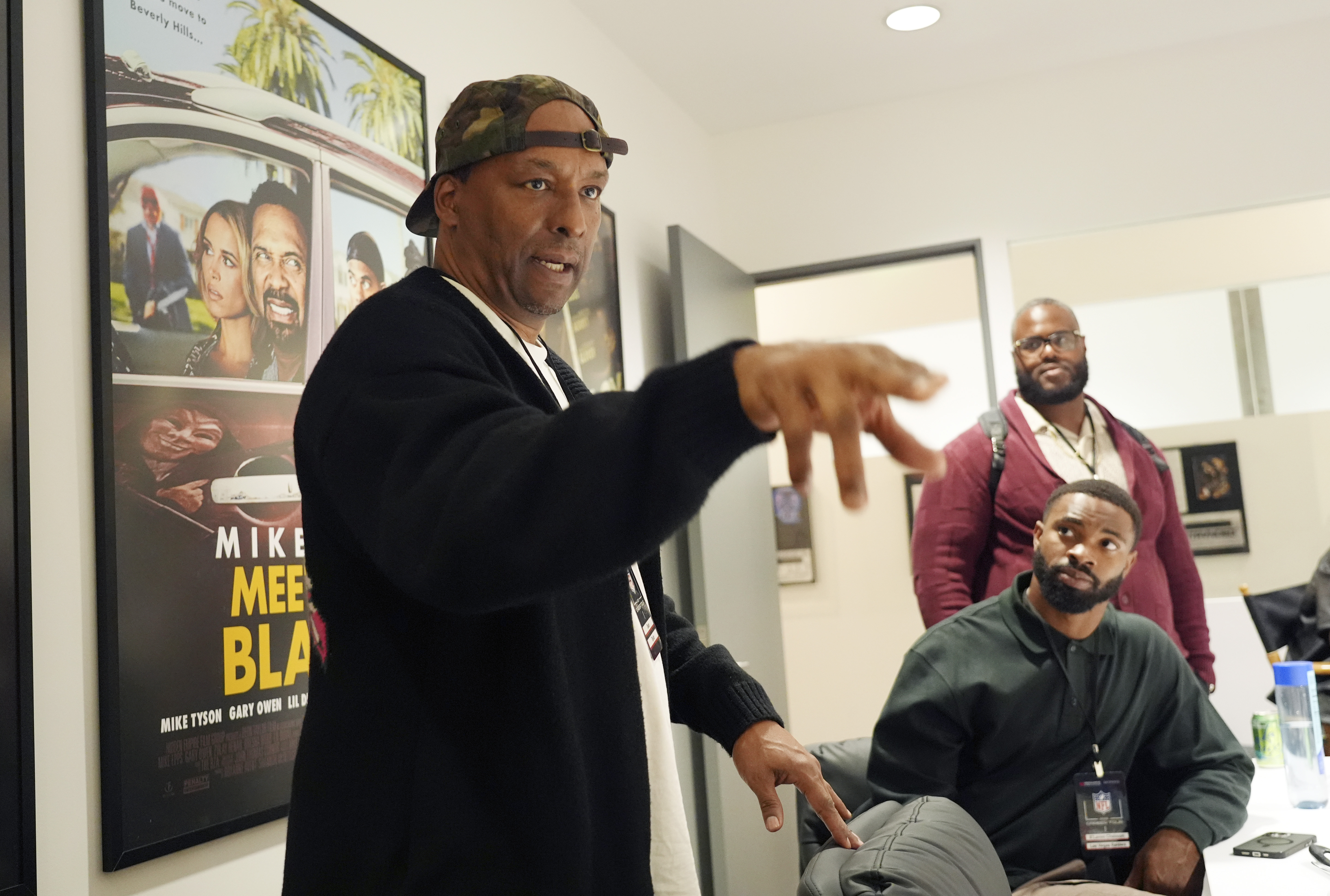 FILE - Filmmaker and former professional basketball player Deon Taylor, left, discusses the movie industry as Las Vegas Raiders linebacker K'Lavon Chaisson, seated, and retired NFL player Reginald Kahlil McKenzie look on during a filmmaking workshop for NFL players on Tuesday, March 4, 2025, in Santa Monica, Calif. 