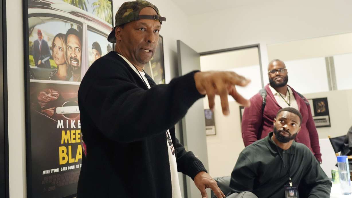 FILE - Filmmaker and former professional basketball player Deon Taylor, left, discusses the movie industry as Las Vegas Raiders linebacker K'Lavon Chaisson, seated, and retired NFL player Reginald Kahlil McKenzie look on during a filmmaking workshop for NFL players on Tuesday, March 4, 2025, in Santa Monica, Calif.