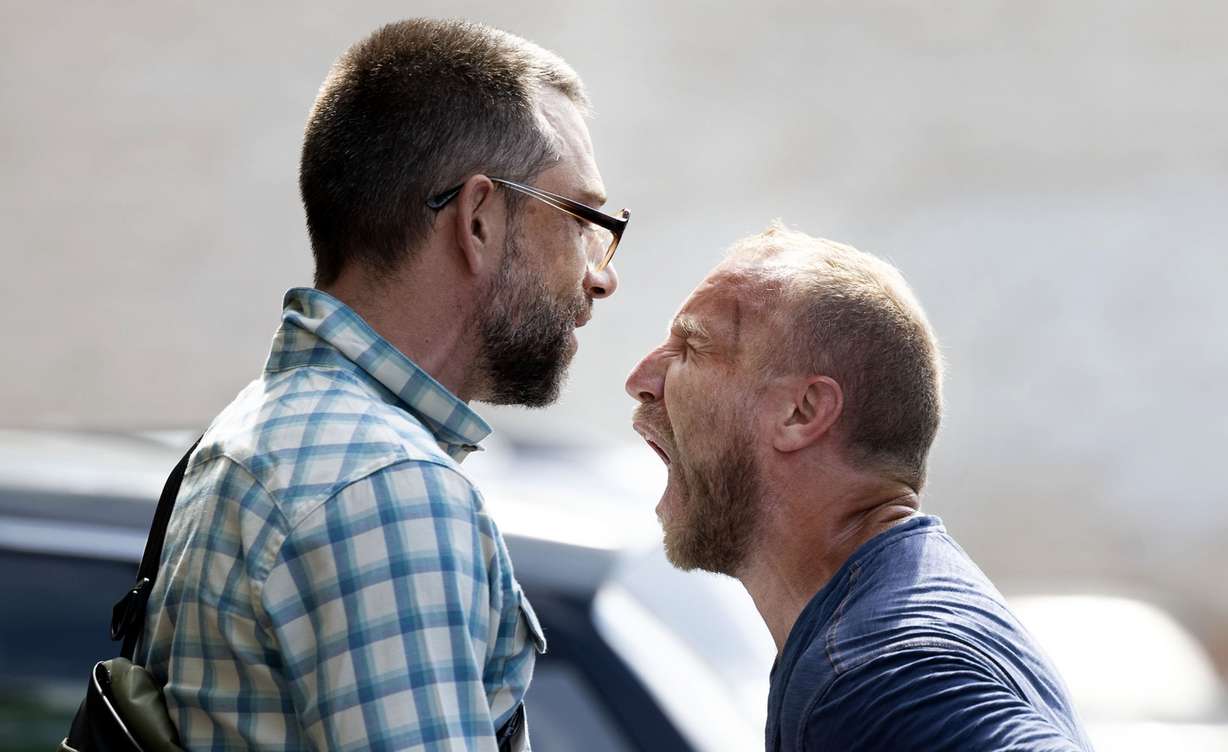 Jonathan Larsen, left, tries to speak to a President Trump supporter outside Utah Rep. Celeste Maloy’s office in Bountiful on Wednesday. About 30 people stood outside Rep. Maloy’s office chanting and writing letters in hopes of her voting against Trump’s budget bill.