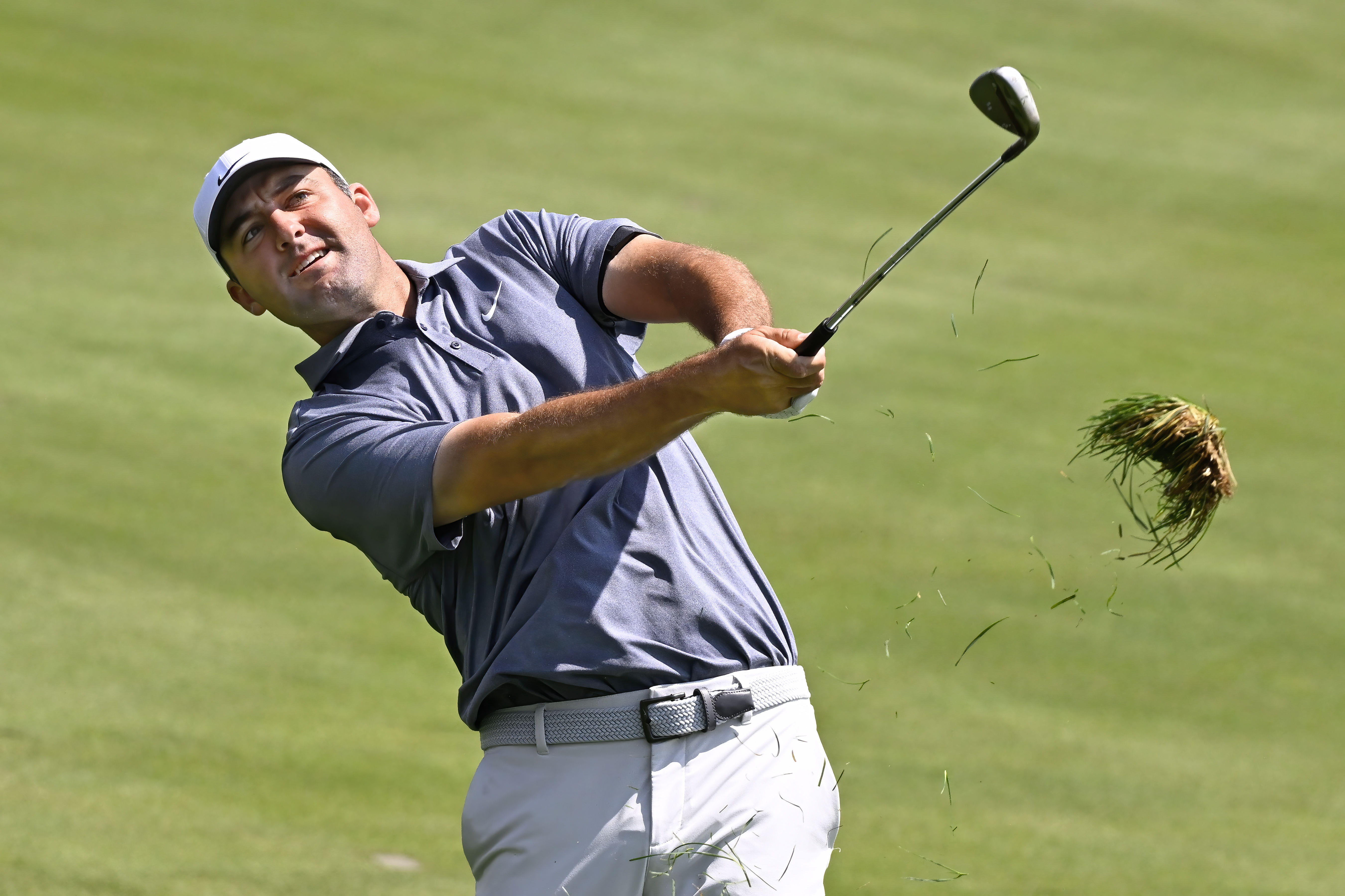 Scottie Scheffler hits his second shot from the rough on the first hole during the second round of the Travelers Championship golf tournament at TPC River Highlands, Friday, June 20, 2025, in Cromwell, Conn.