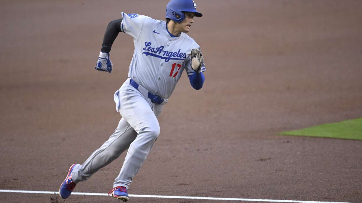 Los Angeles Dodgers' Shohei Ohtani rounds third base before scoring on a double hit by Freddie Freeman, not pictured, during the first inning of a baseball game against the San Diego Padres, Monday, June 9, 2025, in San Diego.