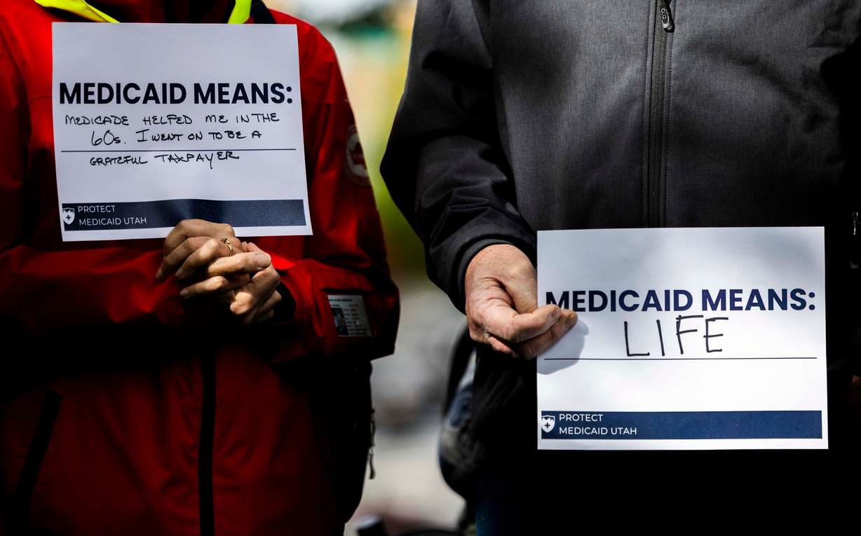 People hold signs supporting Medicaid during a press conference by the newly launched Protect Medicaid Utah coalition at Pioneer Park in Salt Lake City on May 6. Experts are speaking out against potential Medicaid cuts.