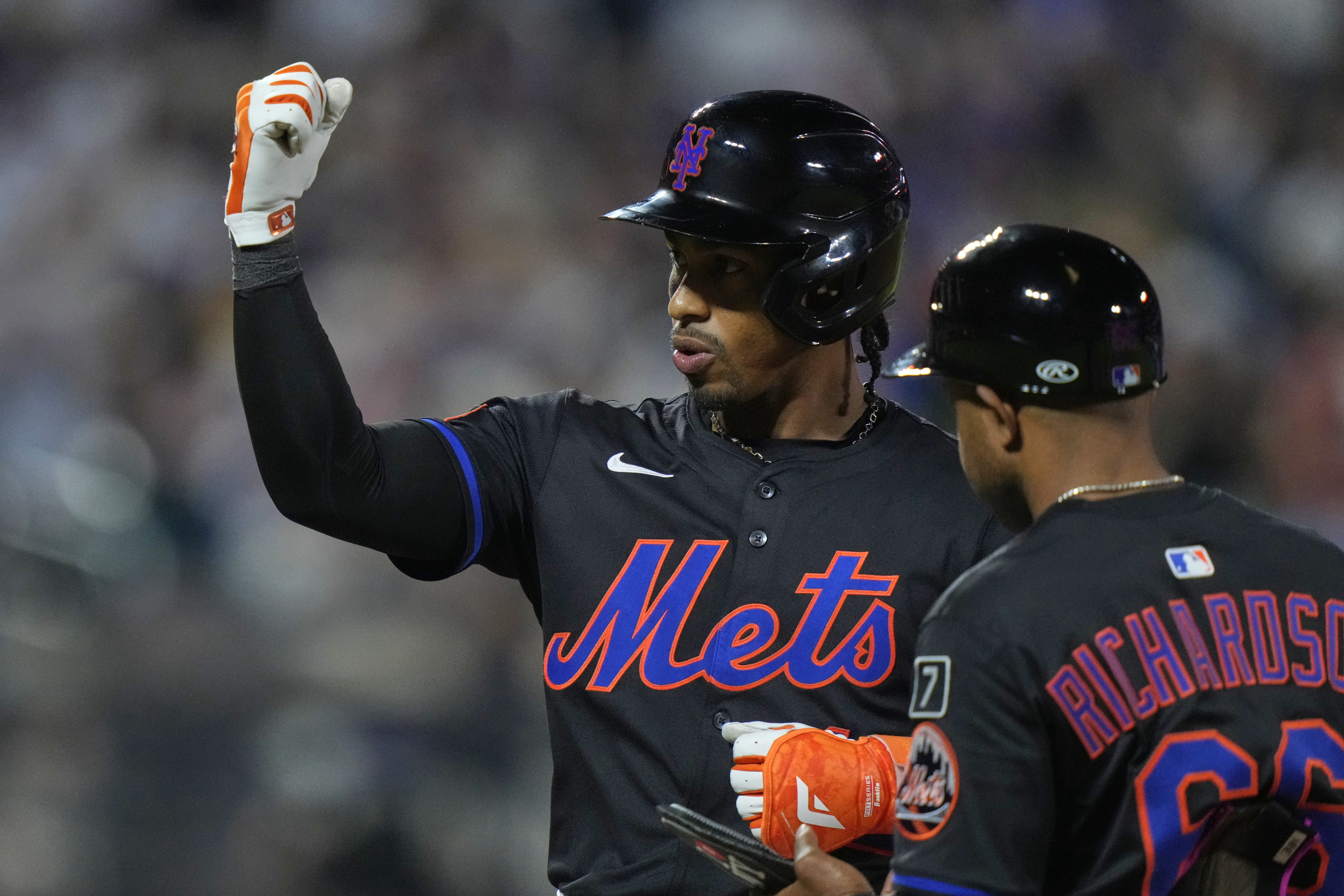 New York Mets' Francisco Lindor gestures to teammates after hitting an RBI single during the sixth inning in the second baseball game against the Milwaukee Brewers of a doubleheader Wednesday, July 2, 2025, in New York.