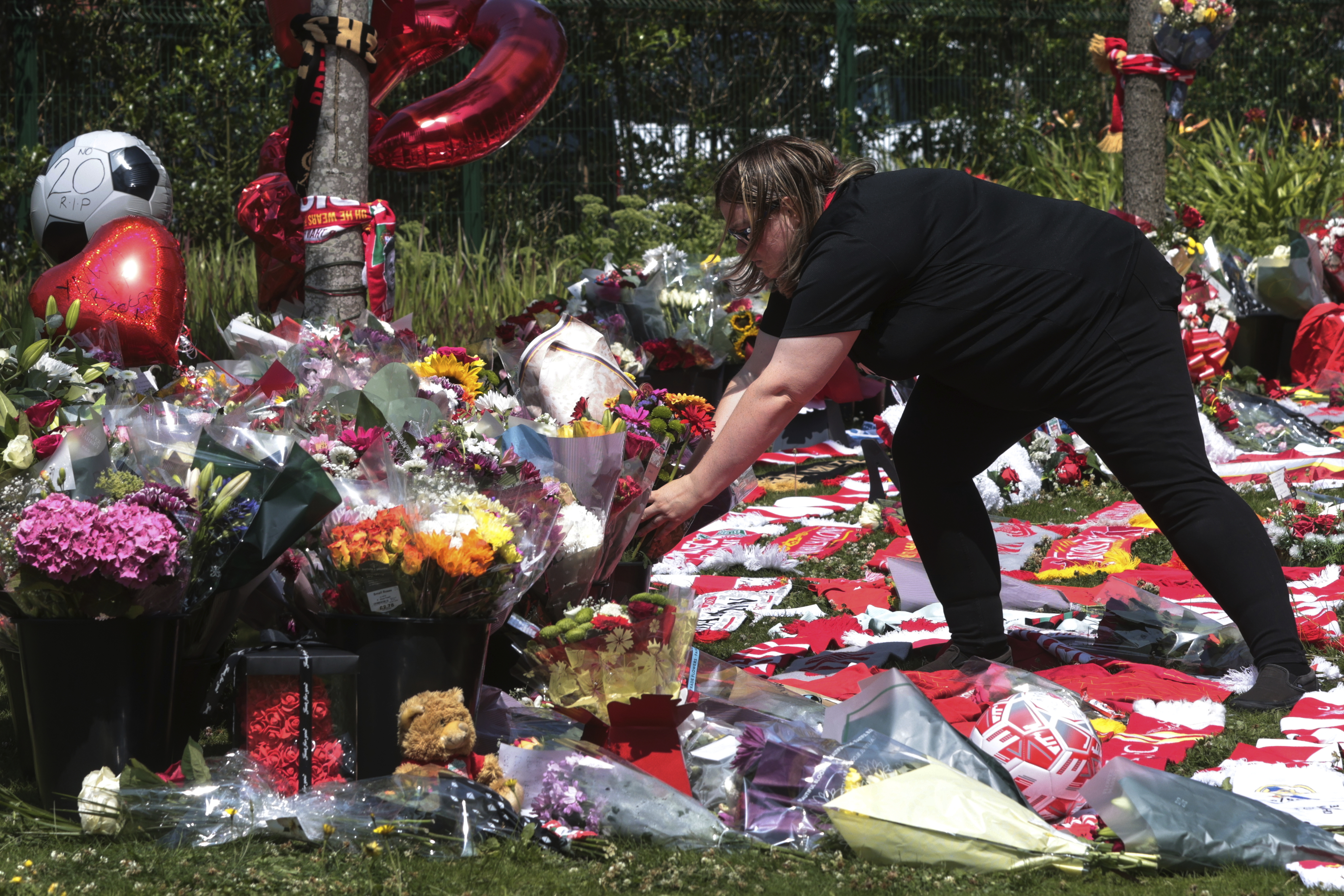 Football fans leave tributes in memory of Liverpool player Diogo Jota at Anfield Stadium, home of FC Liverpool in Liverpool, England Thursday.