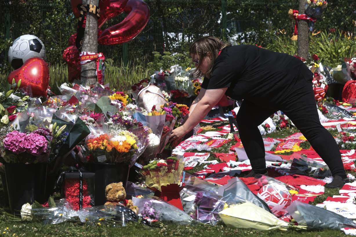 Football fans leave tributes in memory of Liverpool player Diogo Jota at Anfield Stadium, home of FC Liverpool in Liverpool, England Thursday.