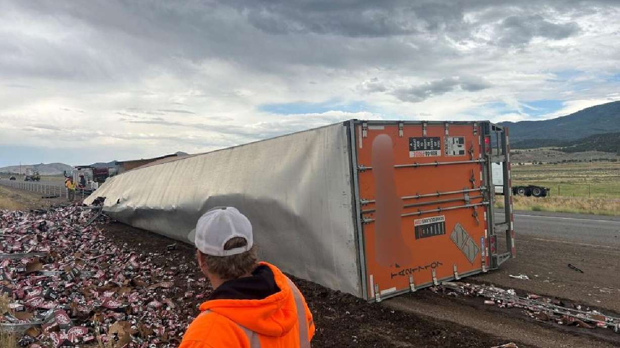 Responders work at the scene where a semitruck tipped over on I-15, spilling its load of Dr Pepper Zero soda in Beaver County on Wednesday.